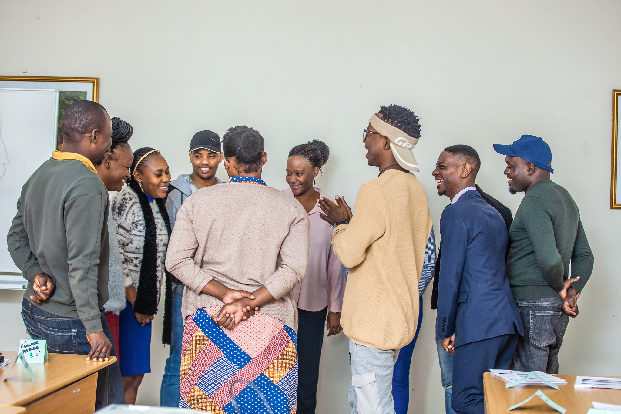 a group of people standing around happily having a discussion