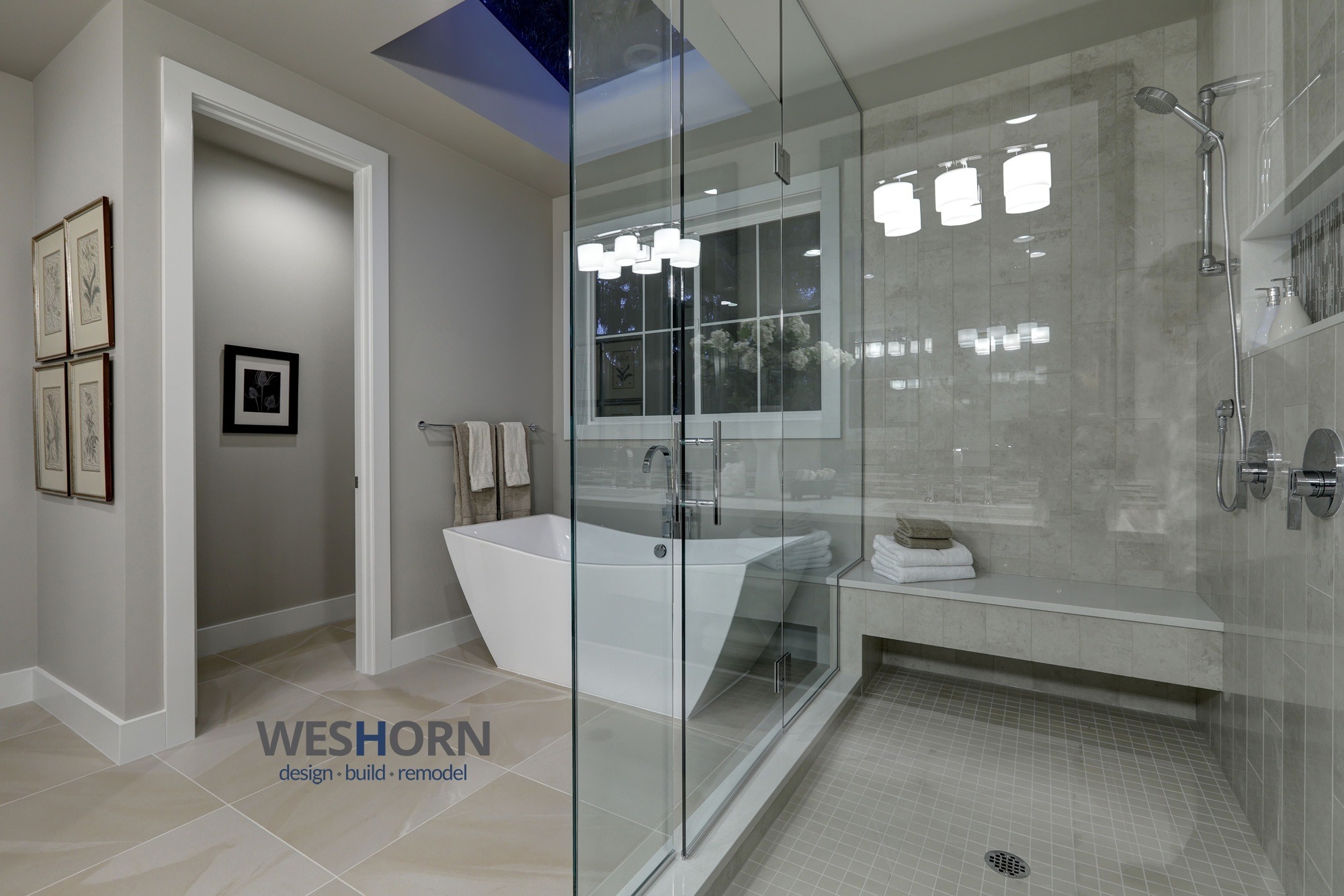 Modern luxury master bathroom featuring a freestanding soaking tub and a spacious glass-enclosed walk-in shower.