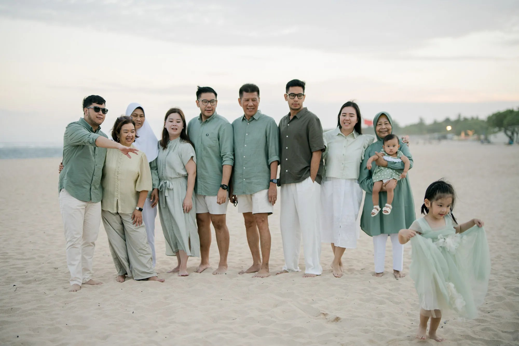 Extended family gathered together on the beach during a multigenerational family photography session in Nusa Dua Bali.