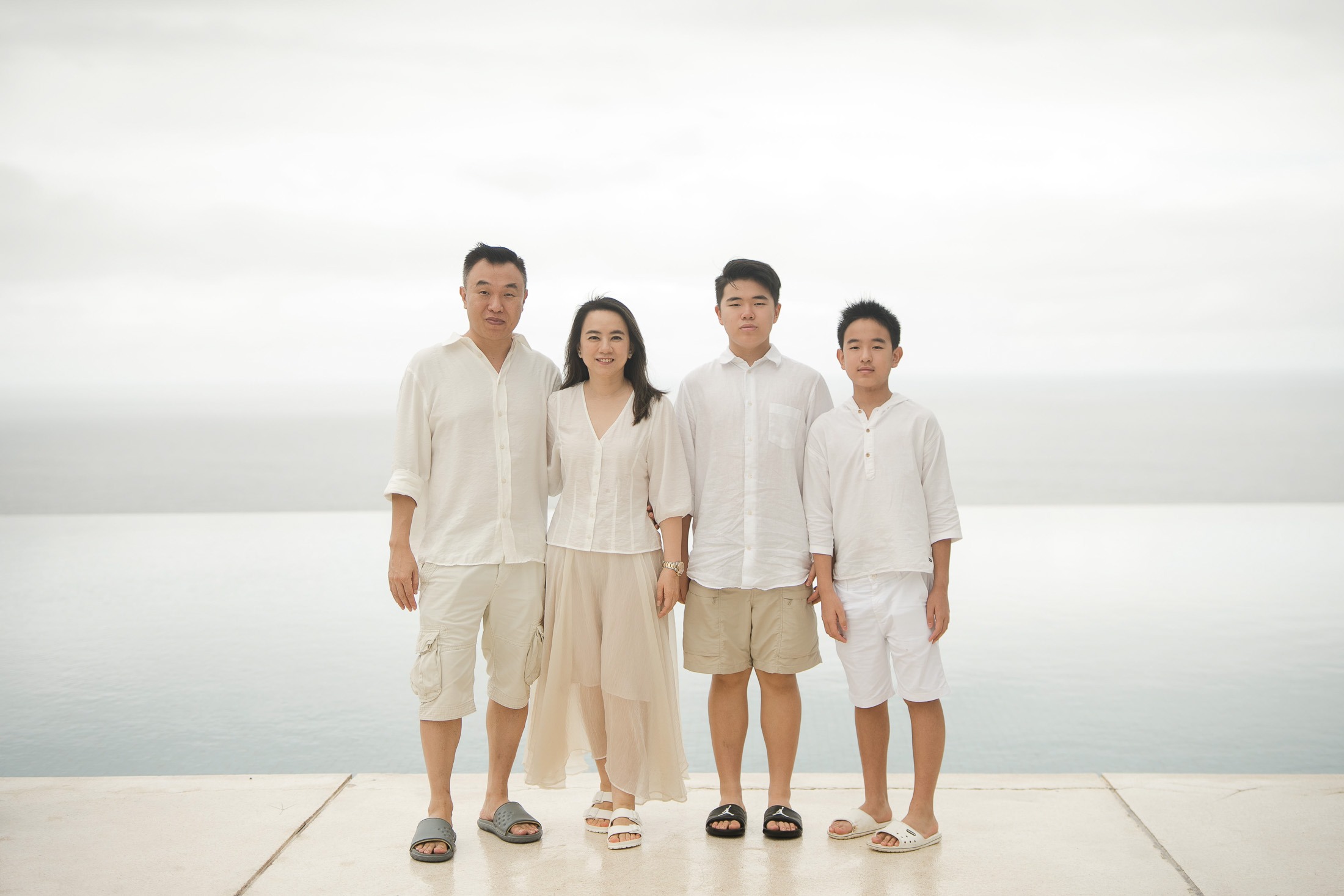 Family portrait with clean neutral background at Alila Villas Uluwatu Bali highlighting connection and simplicity