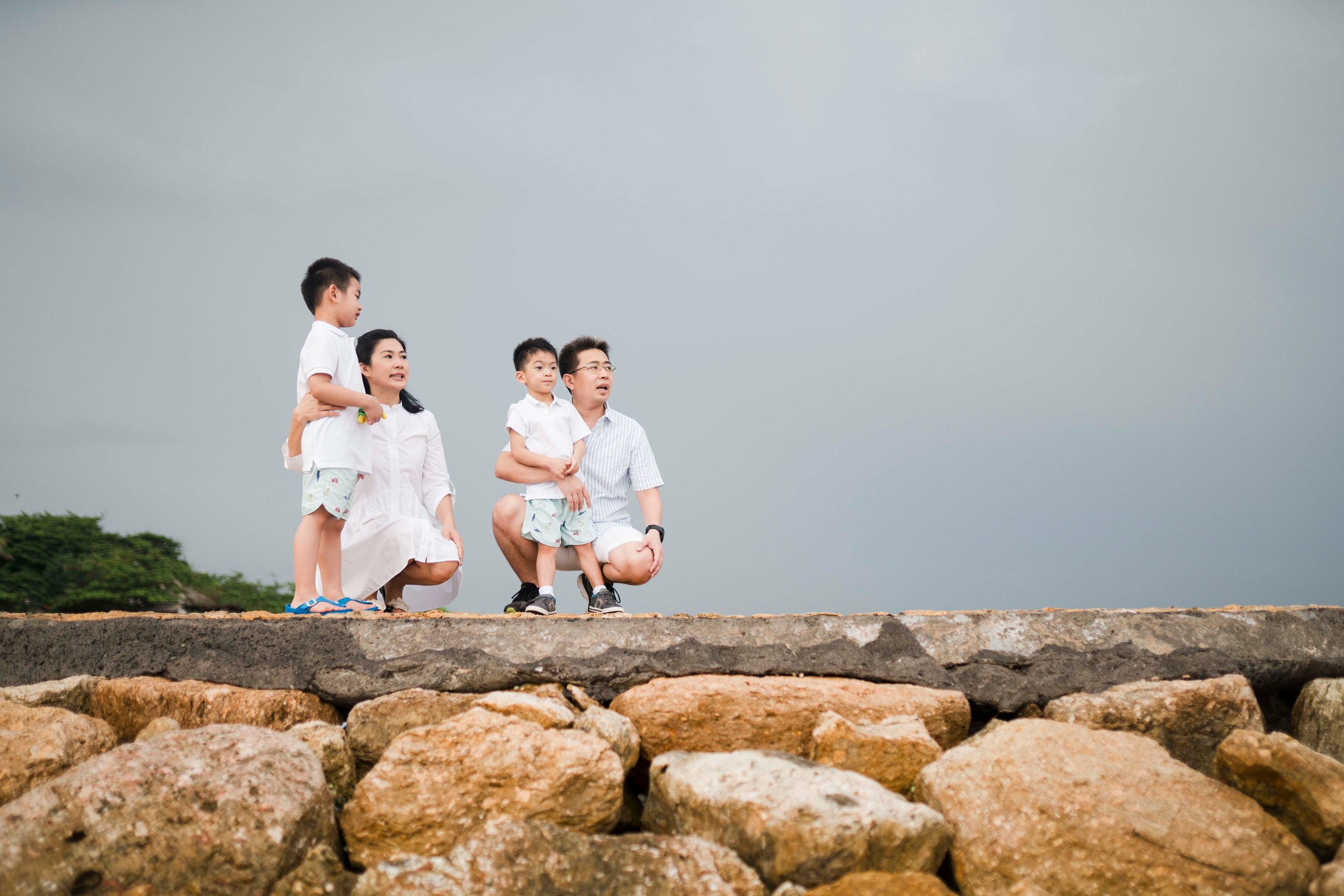 intimate family portrait by the shoreline at Conrad Bali in Nusa Dua