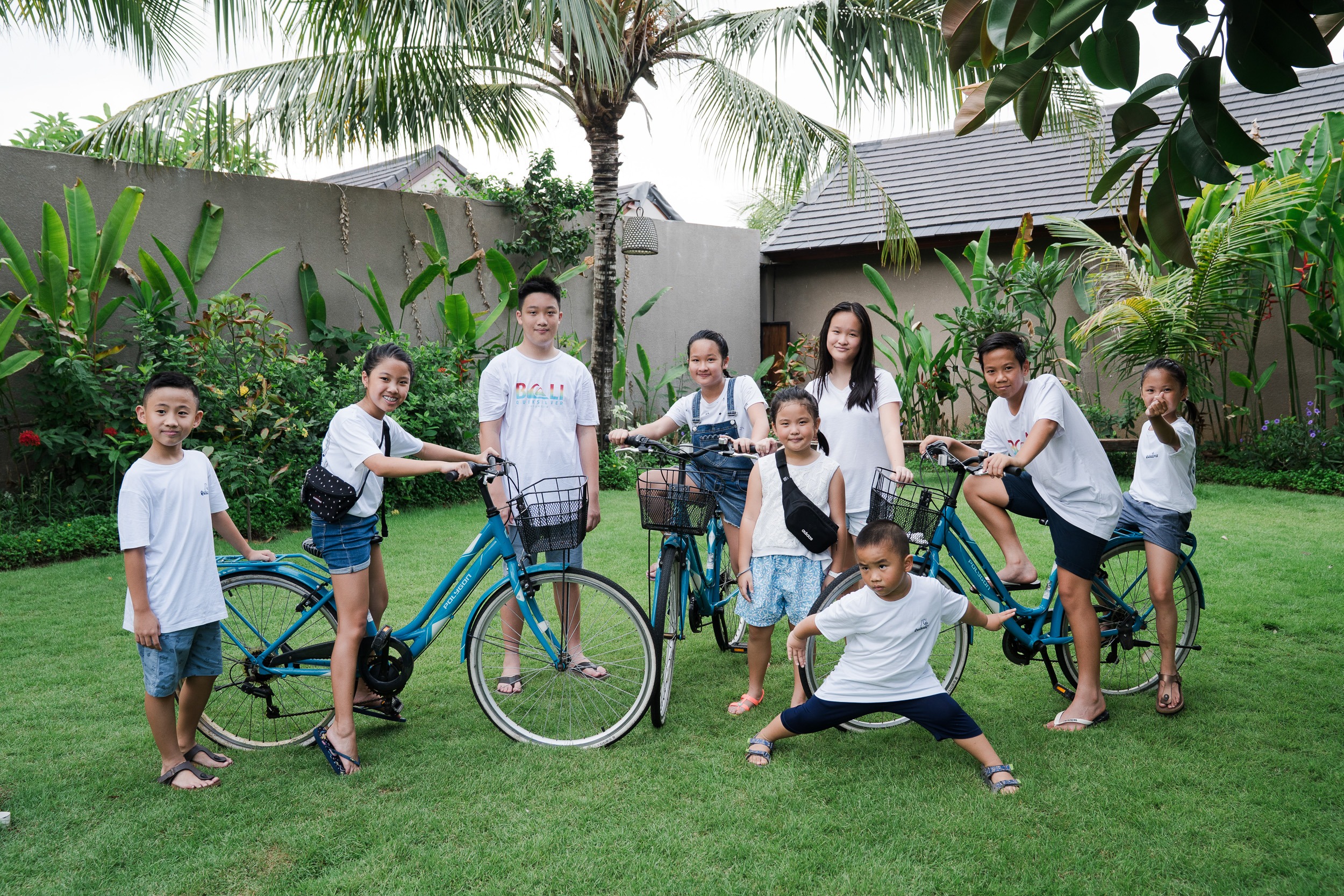 Extended family playful group moment at Lumbini Villas Jimbaran Bali during relaxed outdoor photography session