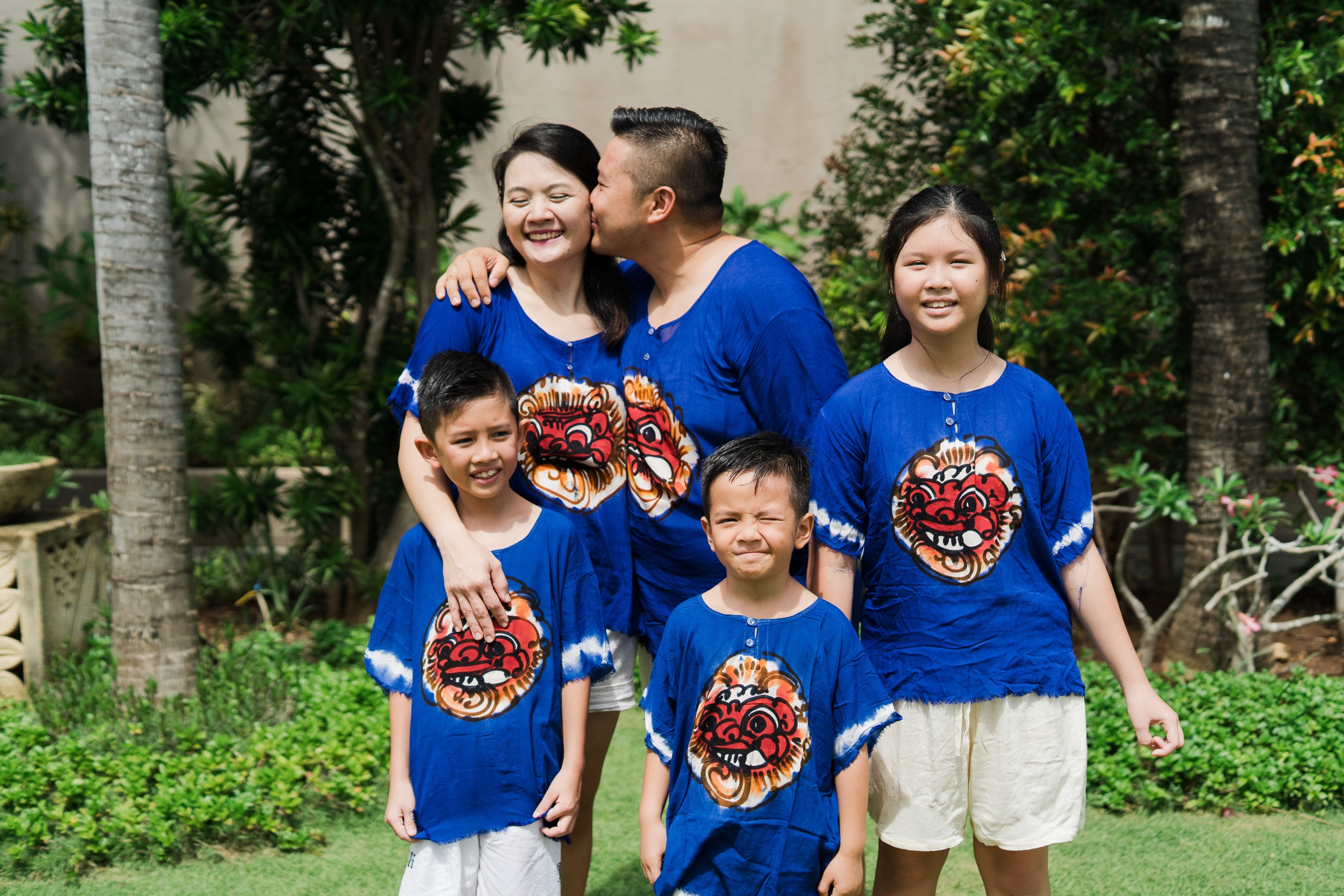 Natural sibling moment during extended family photography session at Lumbini Villas Jimbaran Bali with joyful expressions