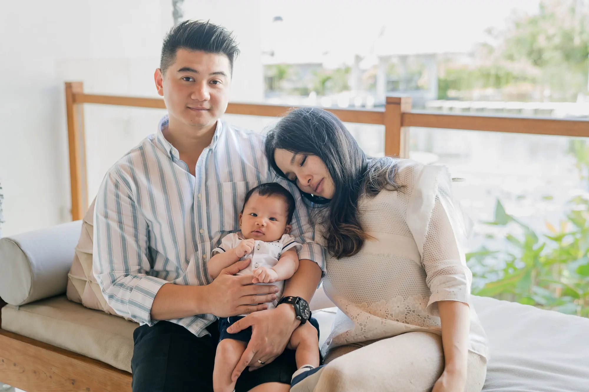 Family portrait with their baby inside a suite at Samabe Bali Suites & Villas in Nusa Dua.