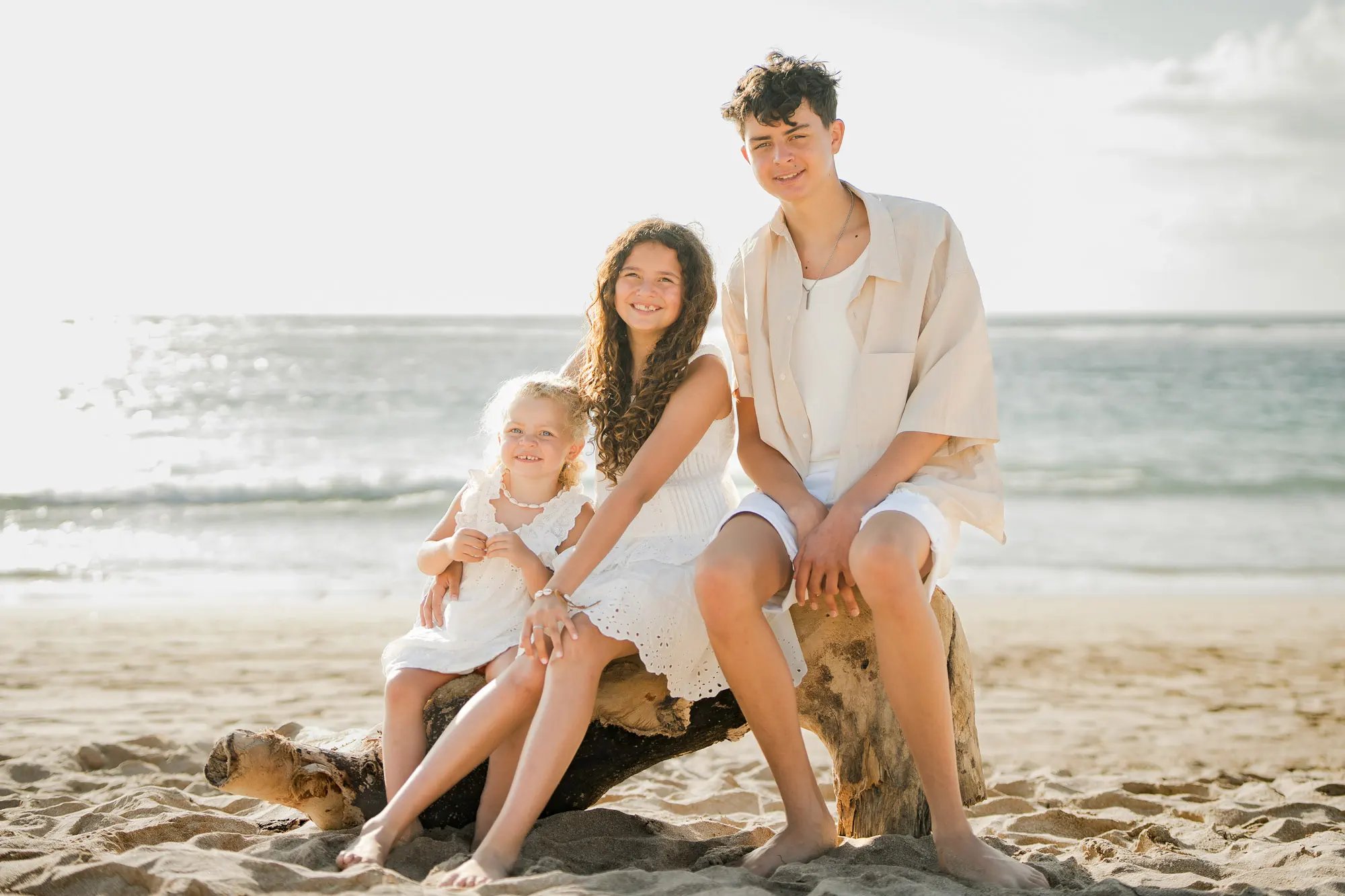 Family portrait captured on the beach during sunset at Ayodya Resort Bali in Nusa Dua