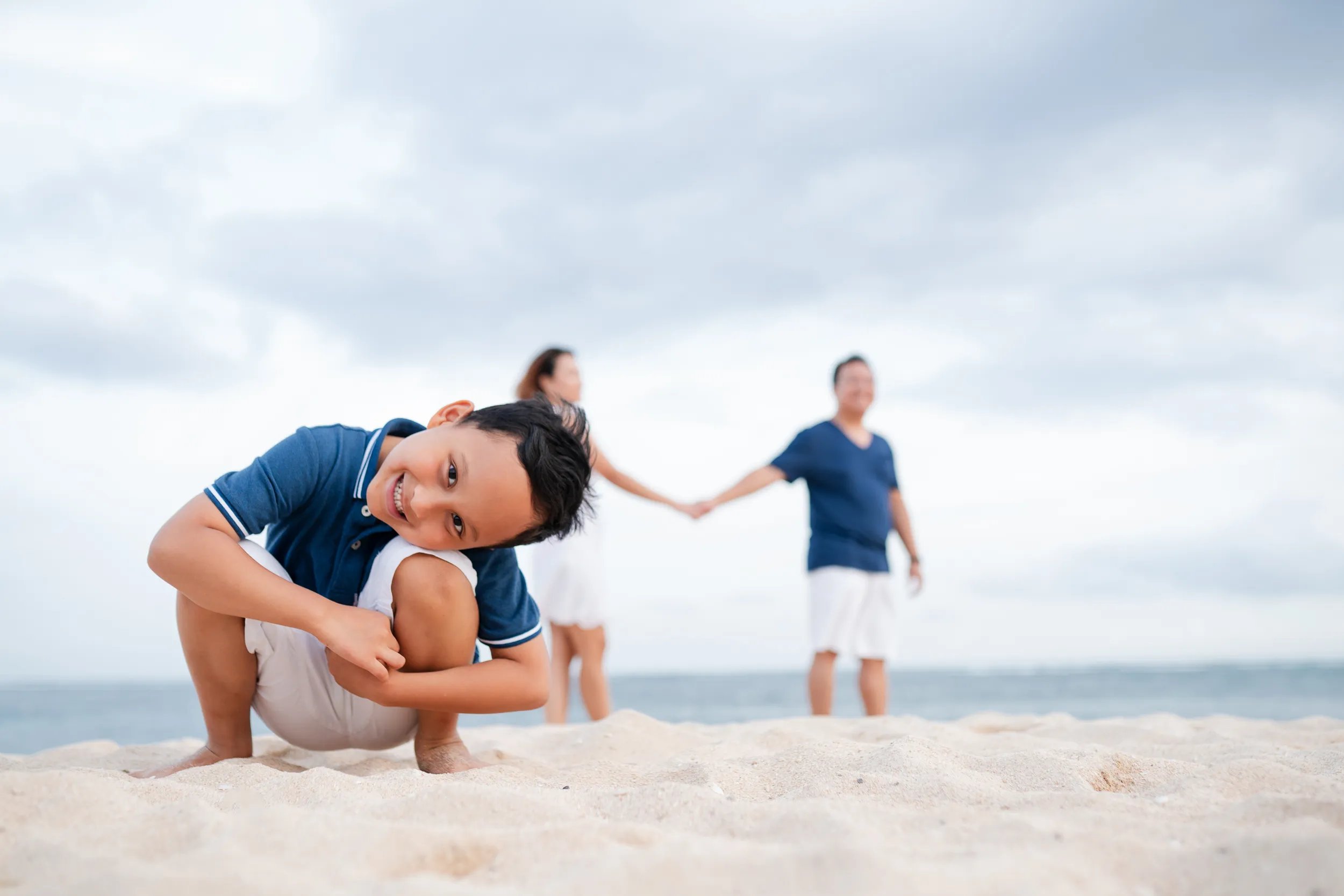 Playful family moment on the beach at The Mulia Nusa Dua Bali