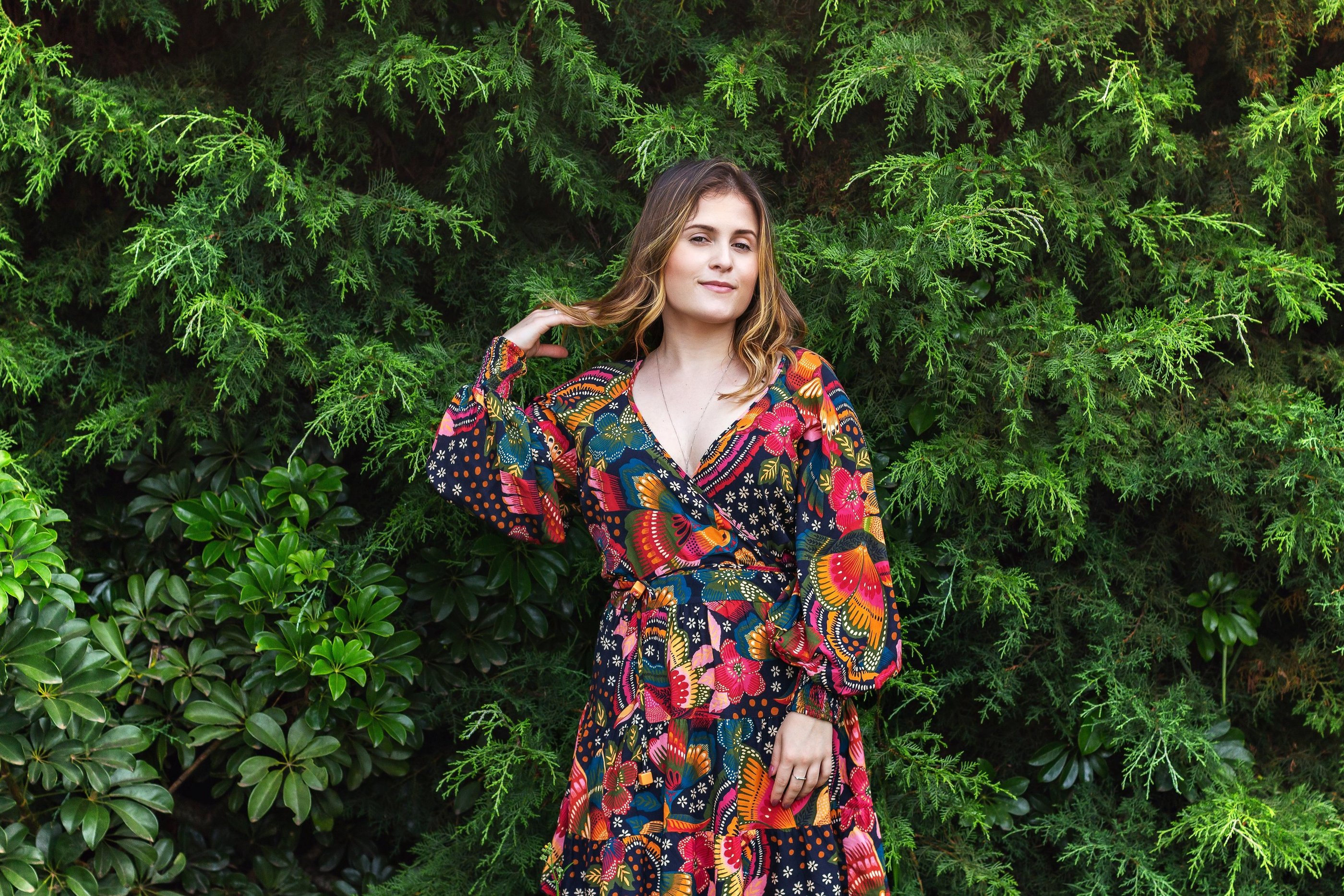 Fashion-inspired outdoor portrait of a woman in a vibrant floral dress