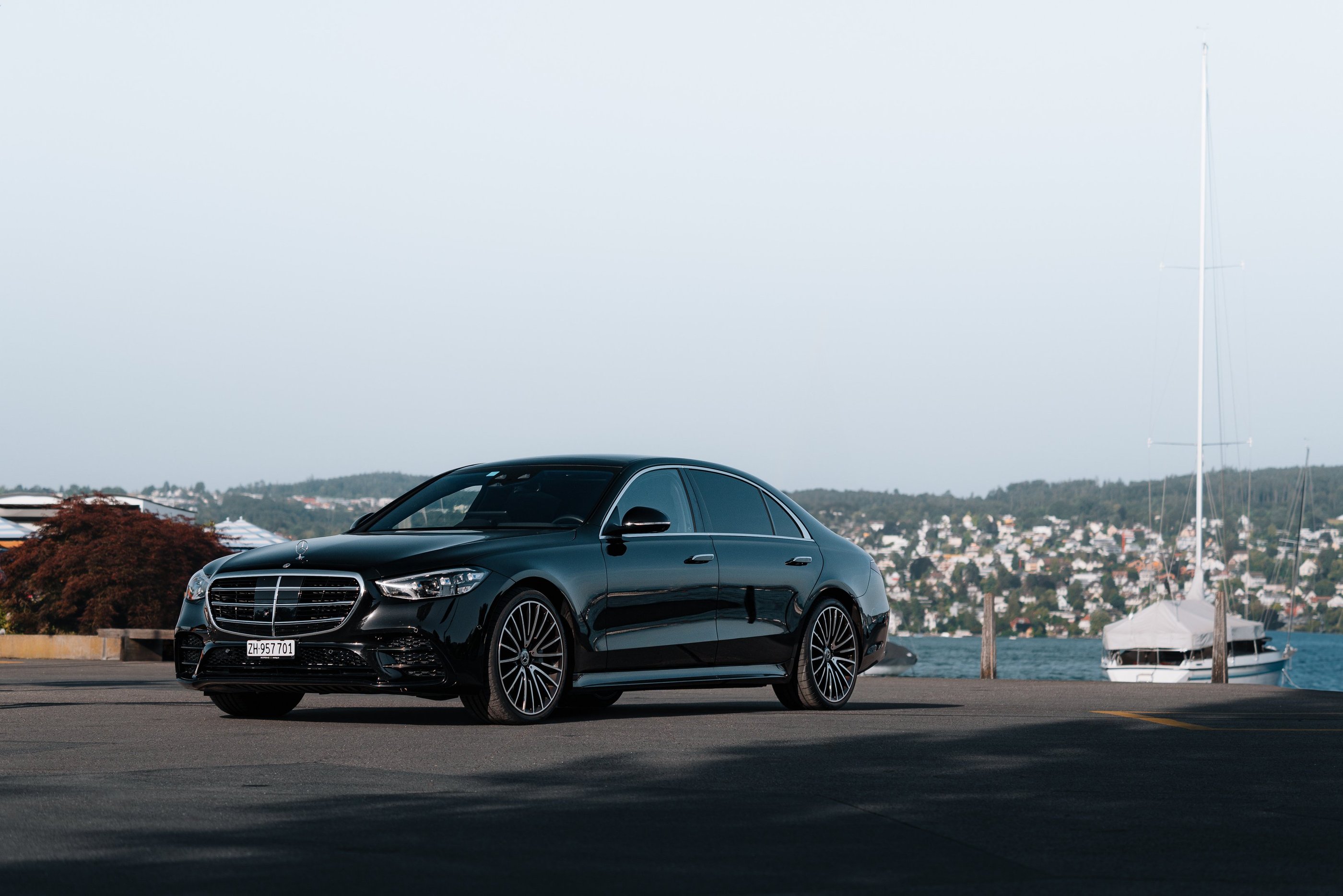 a black mercedes s class on lake zurich