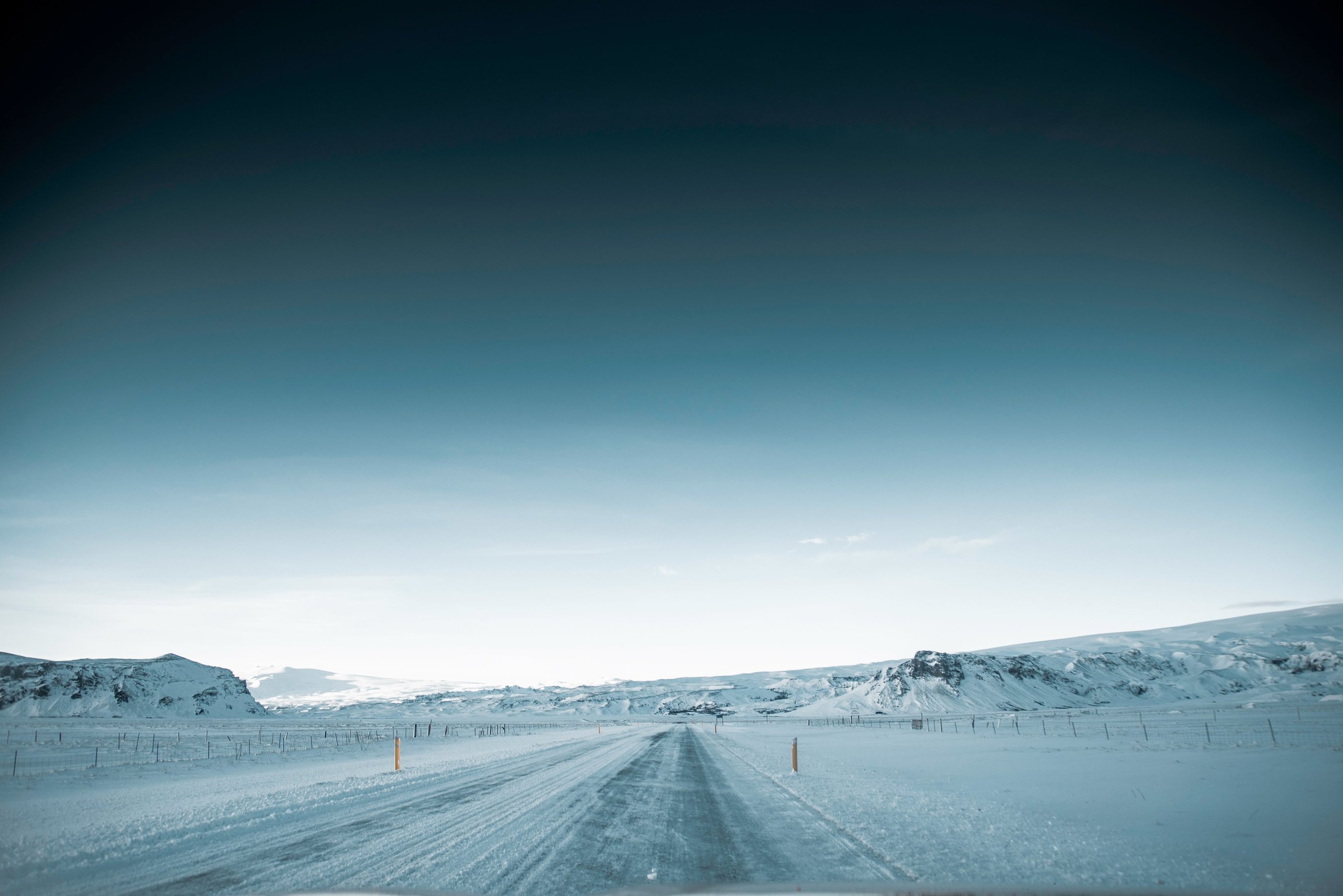 a car driving down a snowy road
