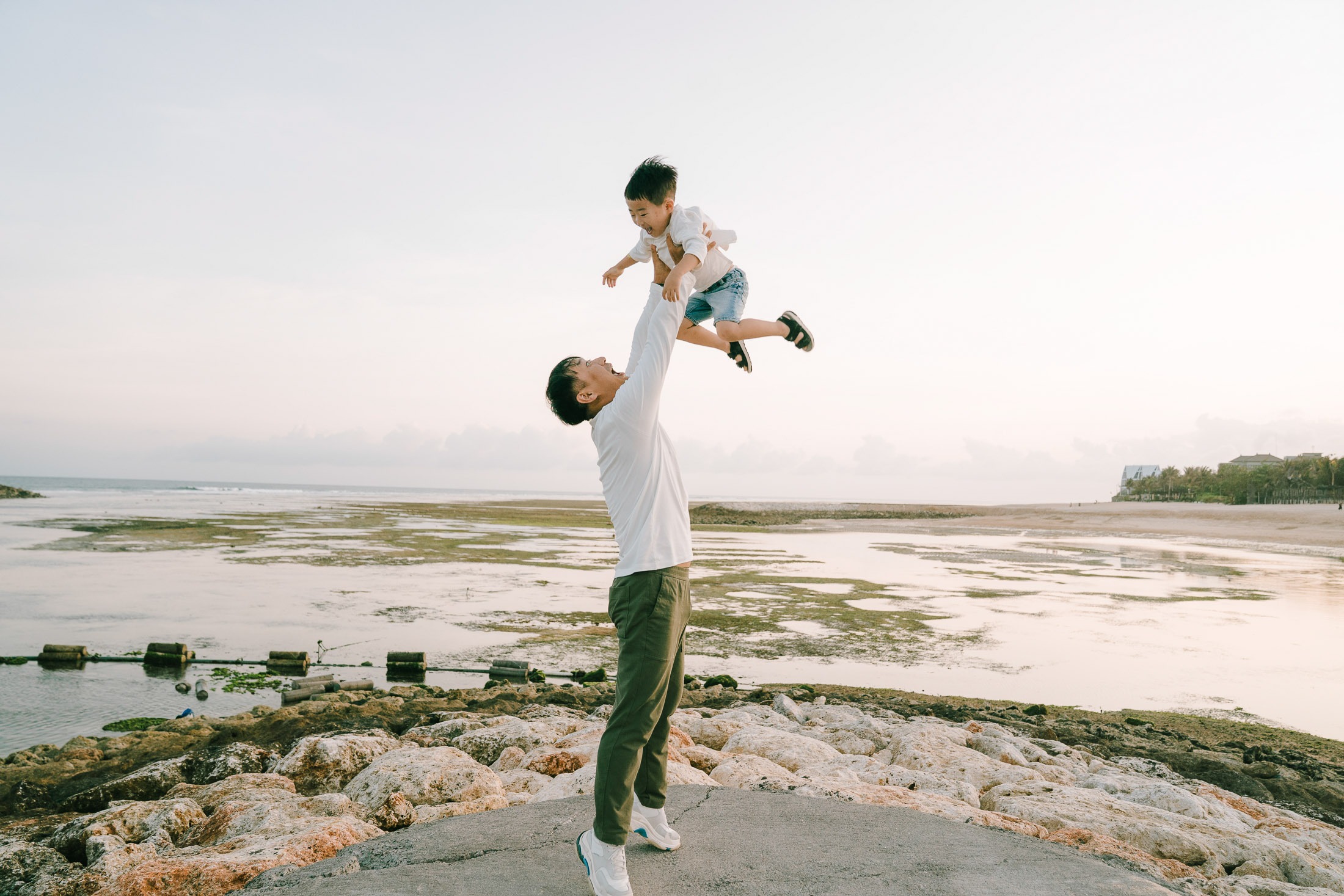 Family portrait on the jetty during a luxury family photography session at The Apurva Kempinski Bali.