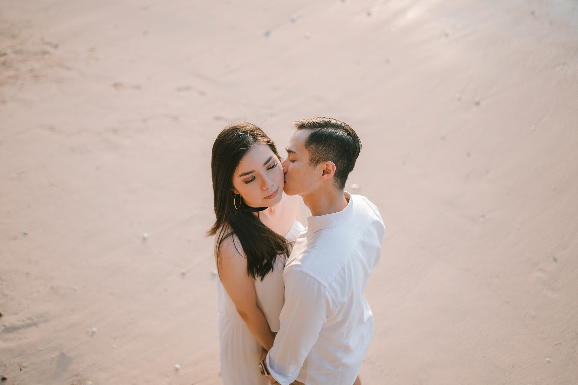 Intimate couple embrace during a proposal photography session at Anantara Uluwatu Bali Resort.