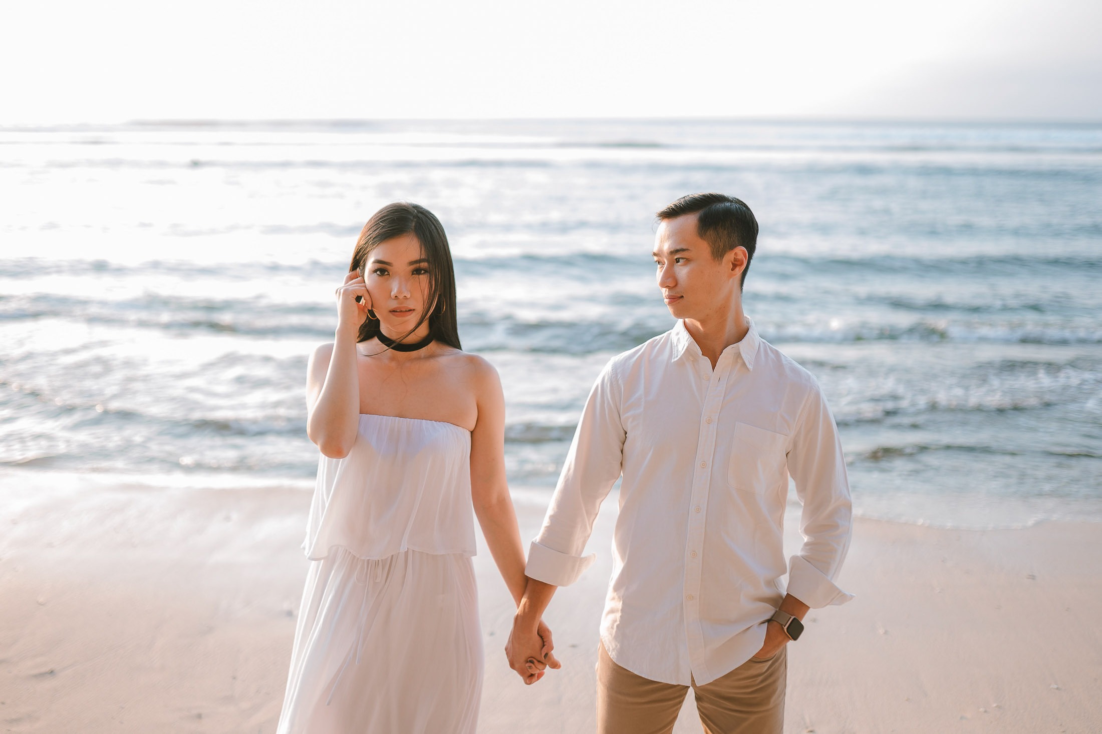 Couple walking on the beach during a proposal photography session at Anantara Uluwatu Bali Resort.