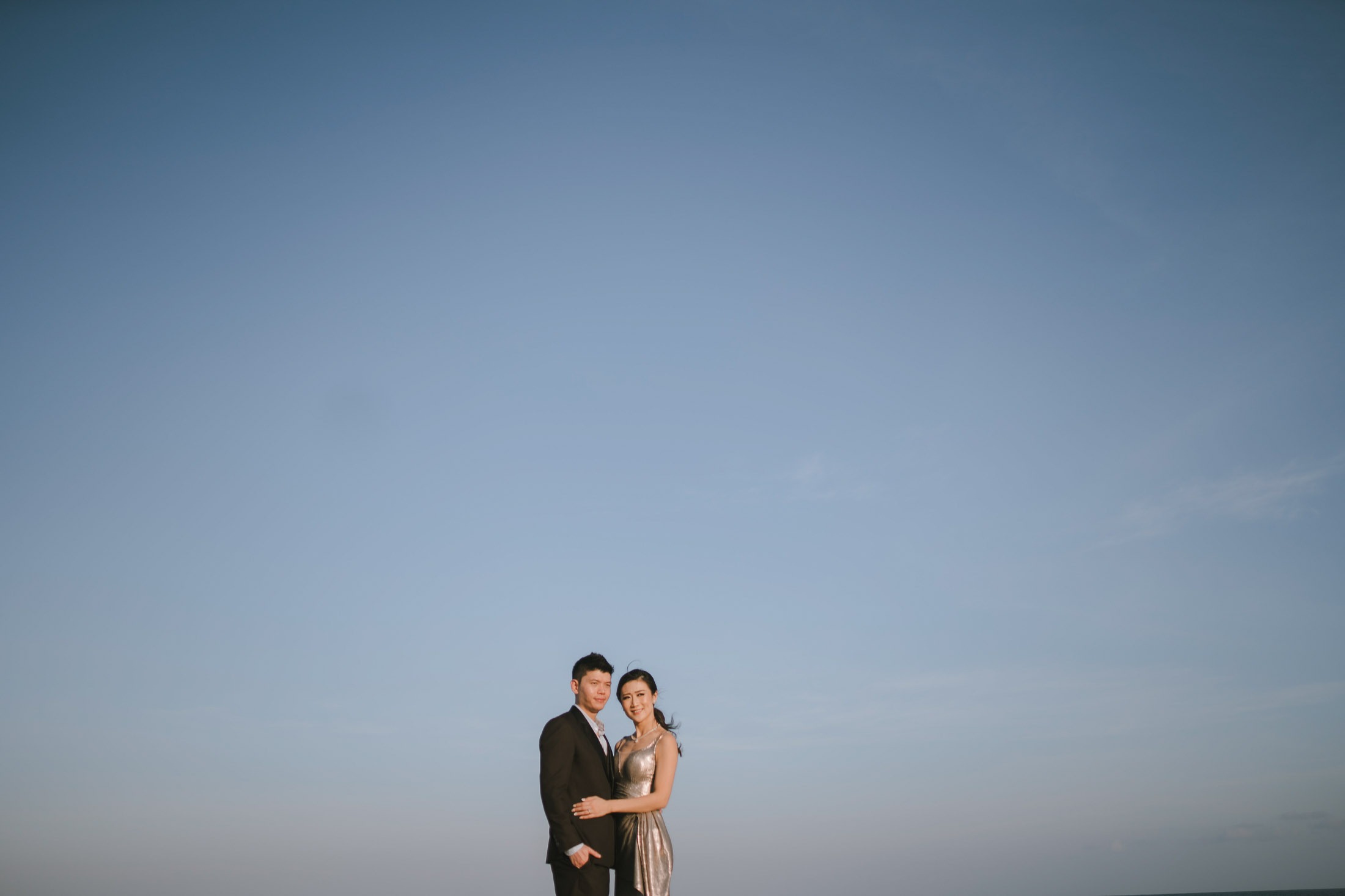 Wide beach prewedding session in Nusa Dua Bali during golden hour.