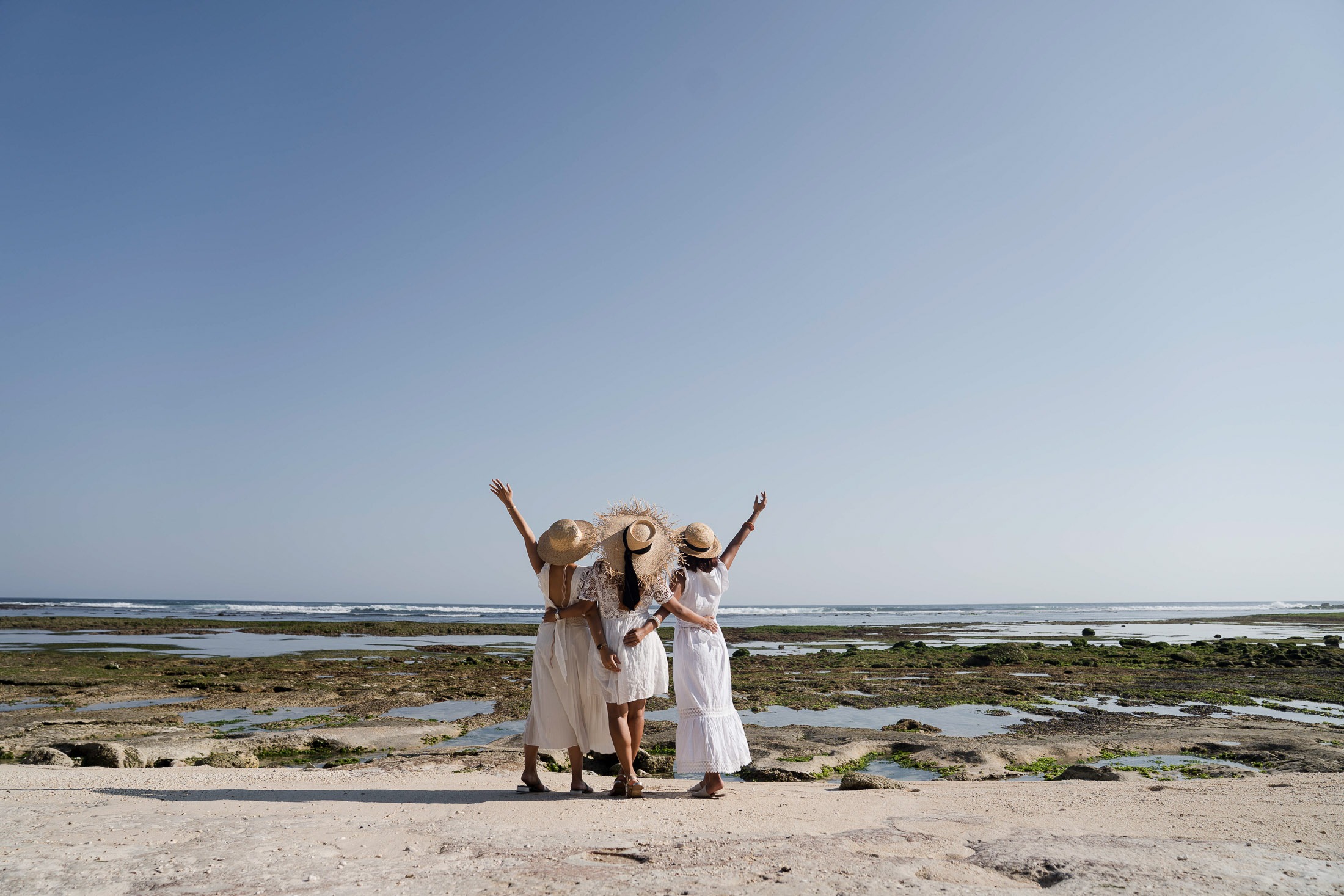 Friends group portrait on coastline during photoshoot at Melasti Beach Bali