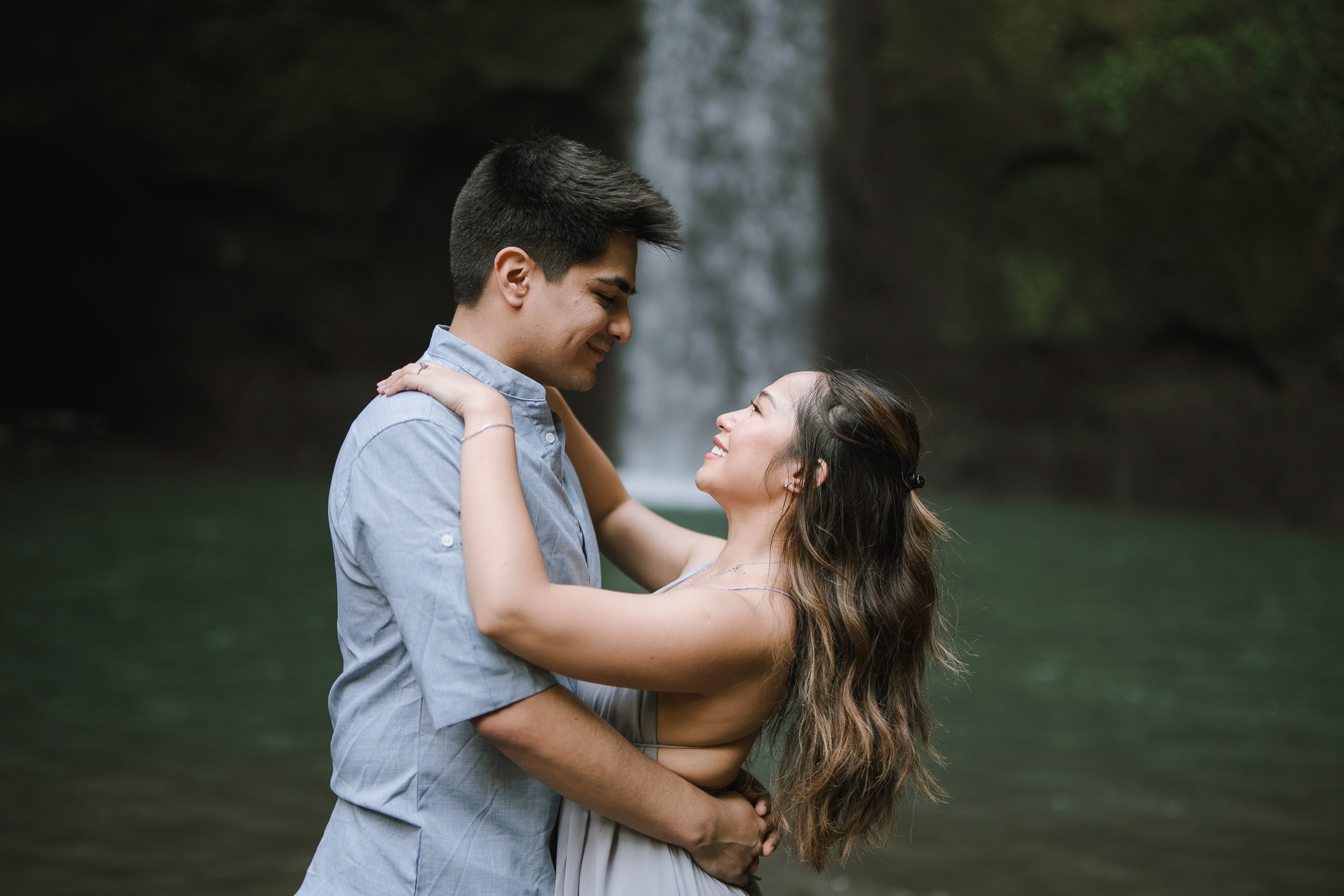 Intimate lift embrace prewedding moment at Tibumana Waterfall Bangli Bali
