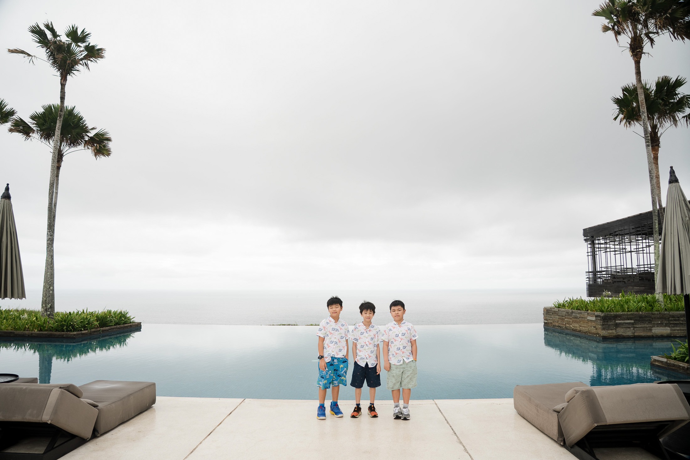 Children portrait in minimal architectural setting at Alila Villas Uluwatu Bali with soft natural light