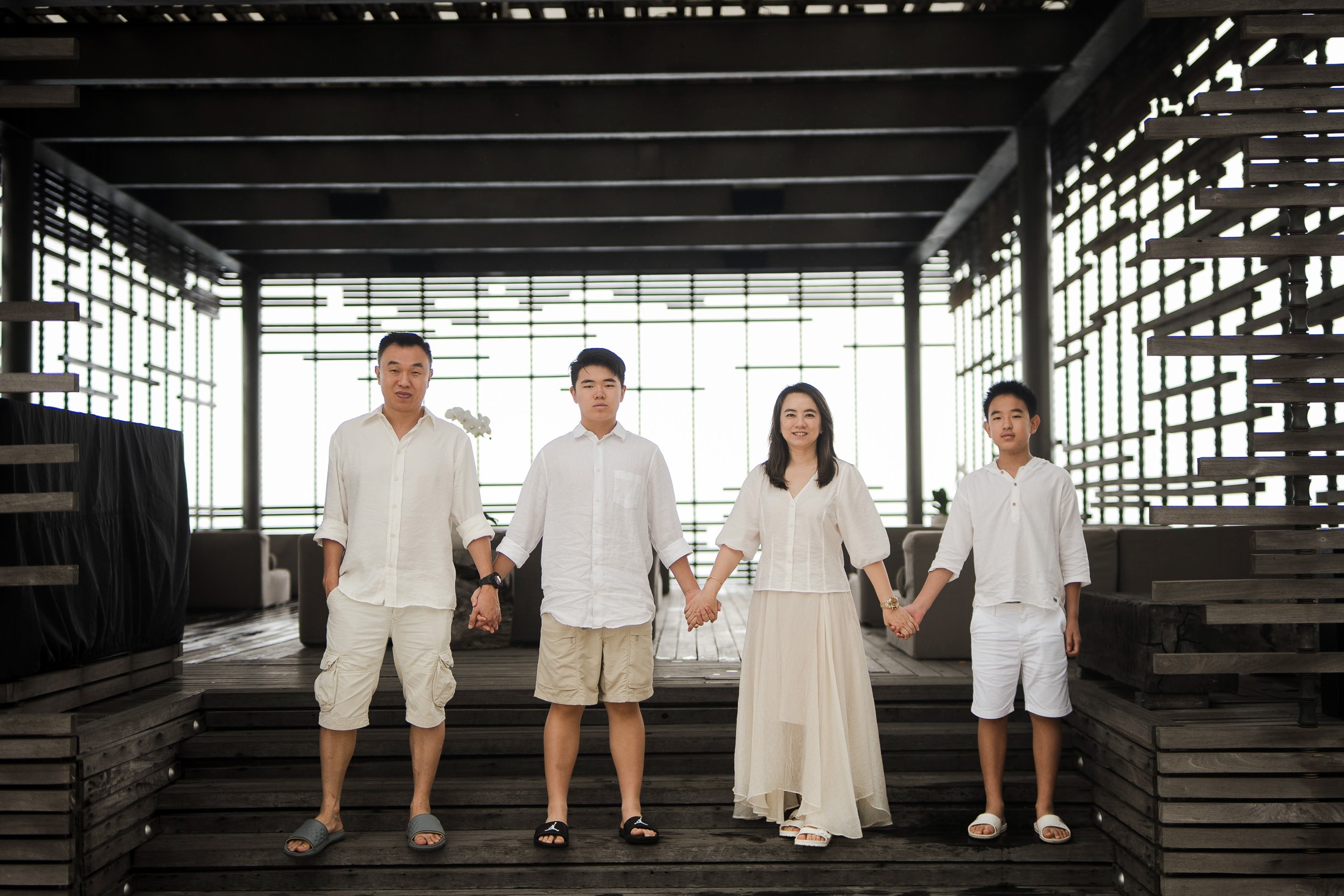 Family portrait in structured architectural space at Alila Villas Uluwatu Bali with clean composition and soft light  