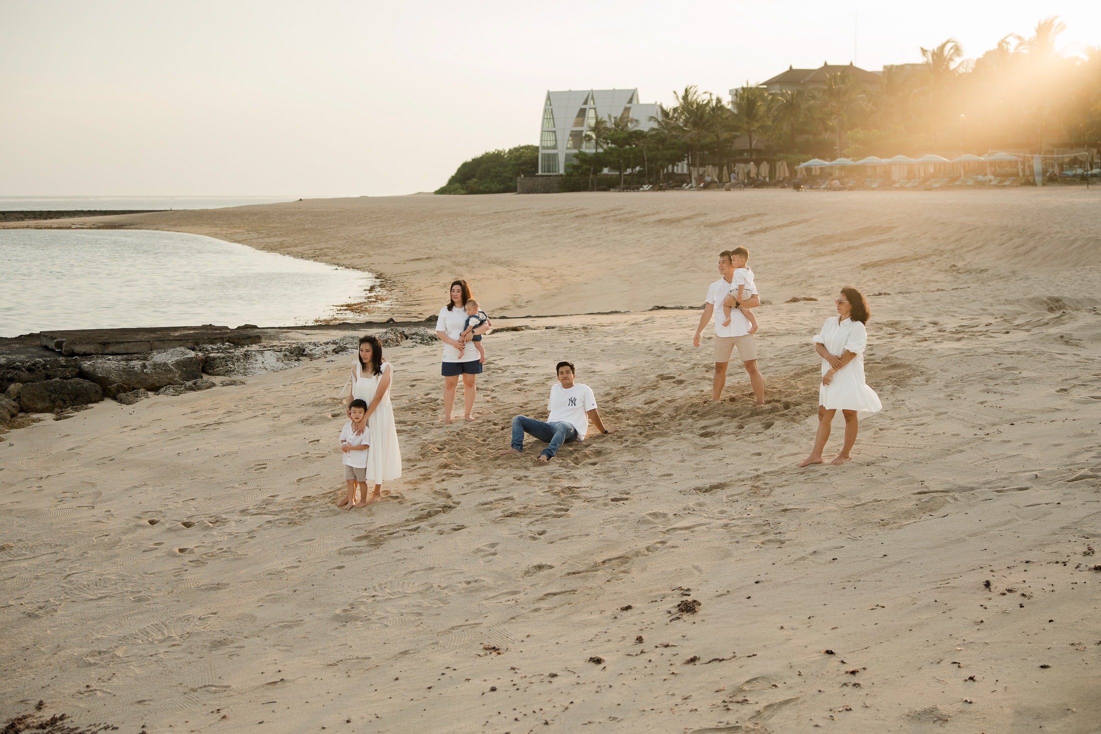 Children playing on the beach during a relaxed family photography session at The Apurva Kempinski Nusa Dua Bali