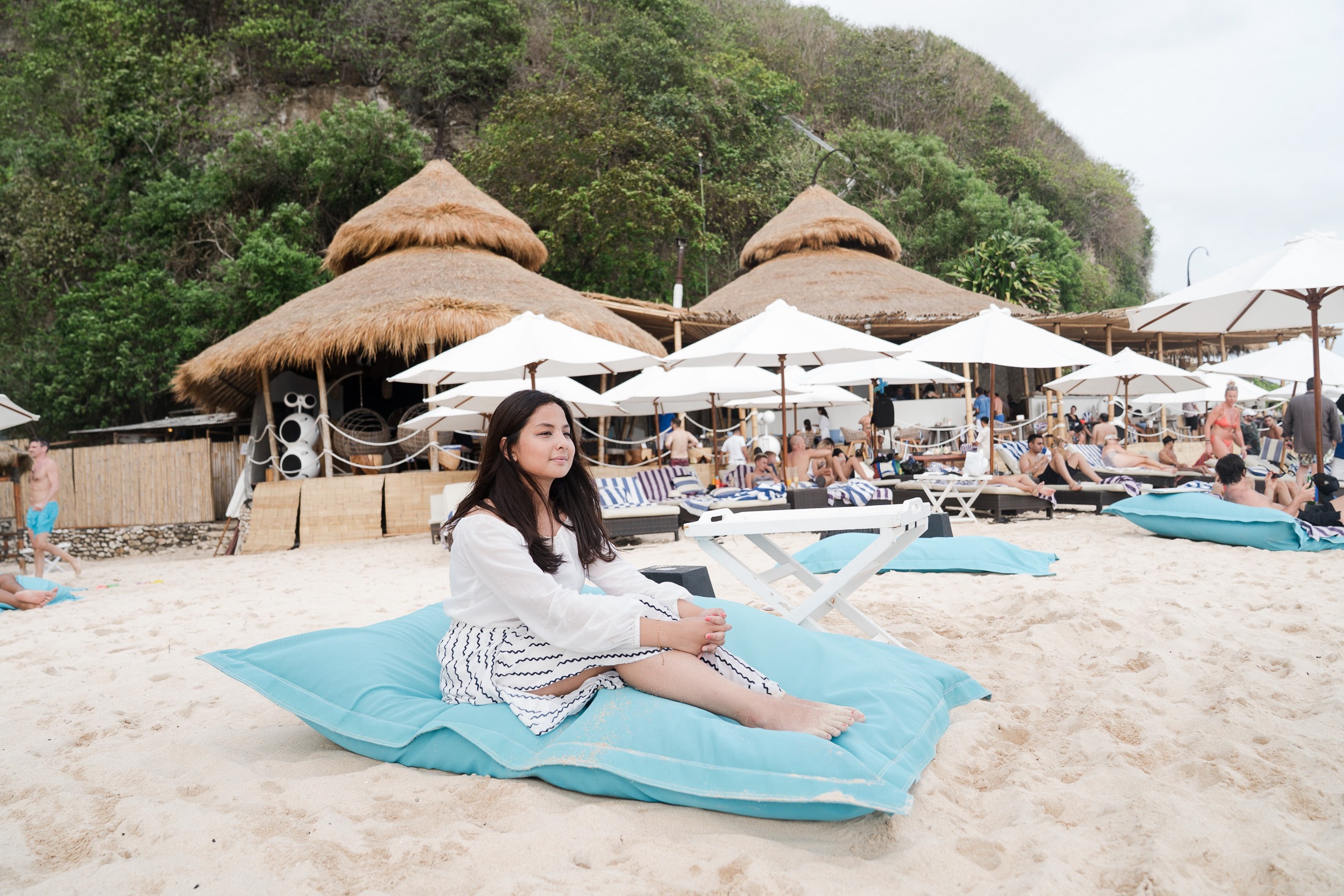 Family relaxing at Karma Kandara Bali resort pool with cliffside ocean view  