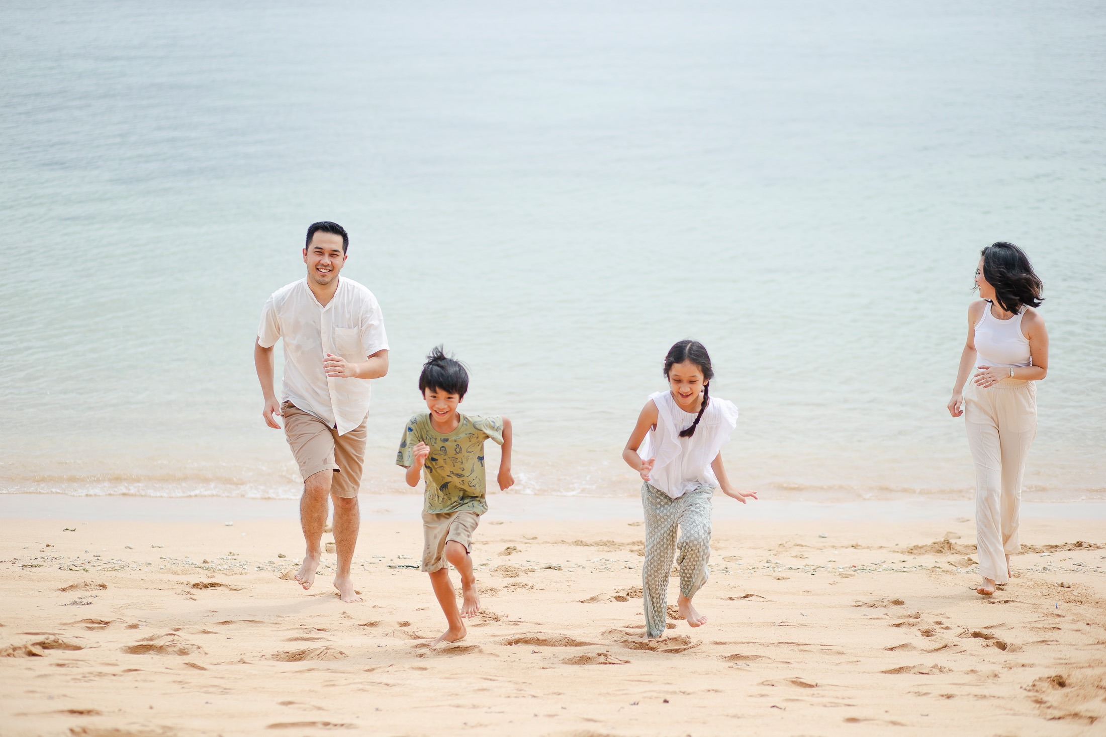 family walking together during beach session at Westin Nusa Dua Bali