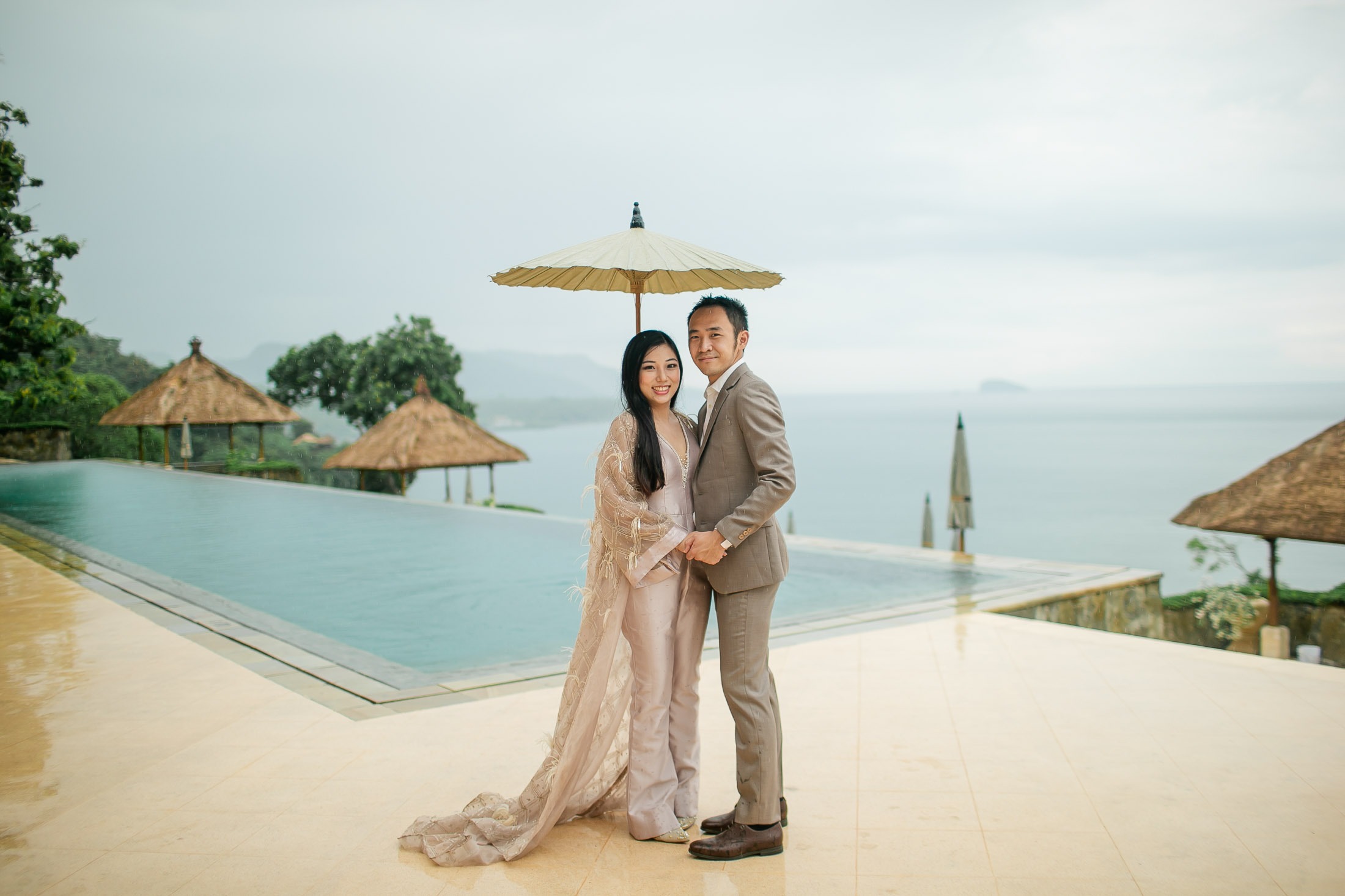 Elegant prewedding couple at Amankila infinity pool in Karangasem East Bali