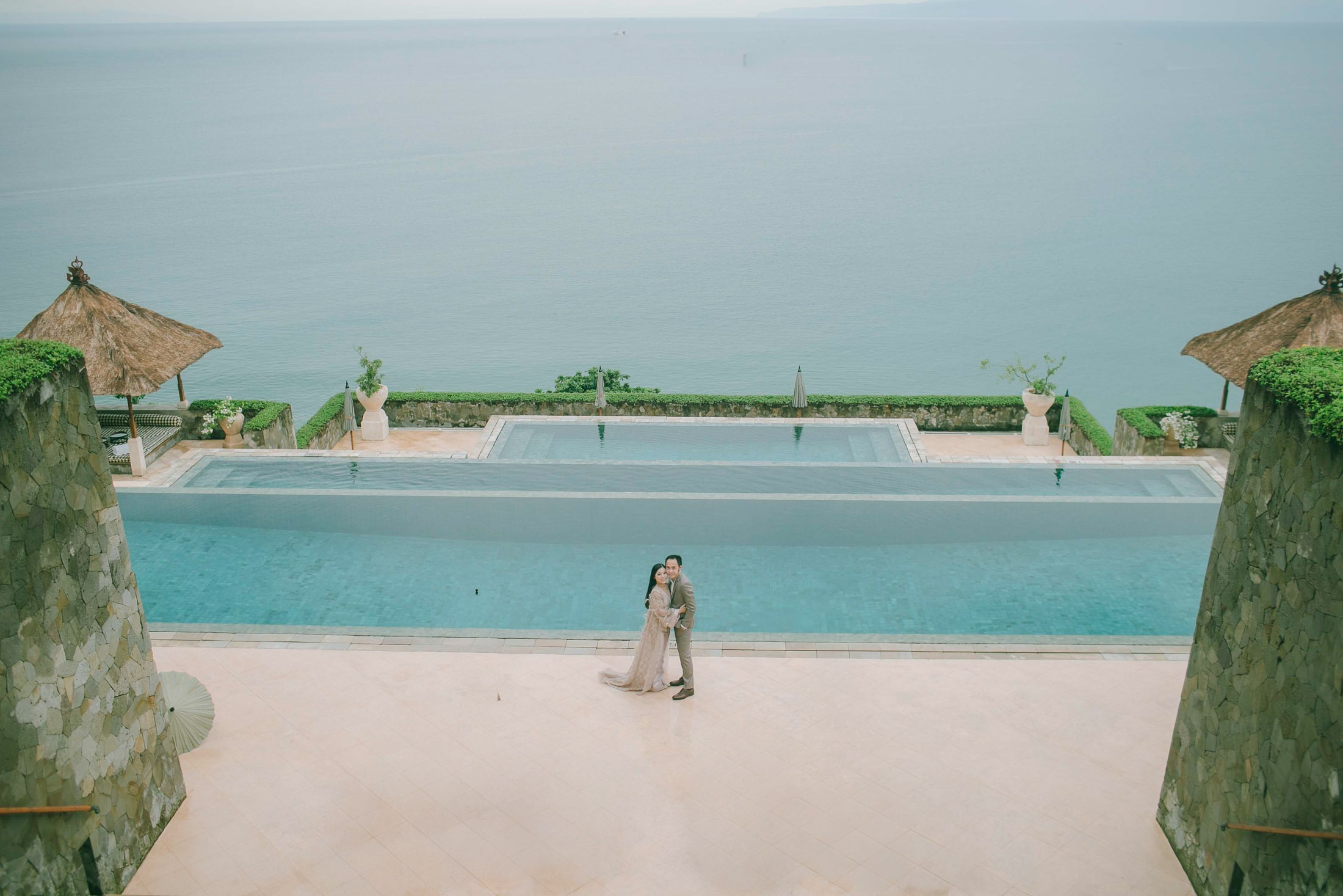 Elegant prewedding session at Amankila infinity pool overlooking the ocean in Karangasem Bali