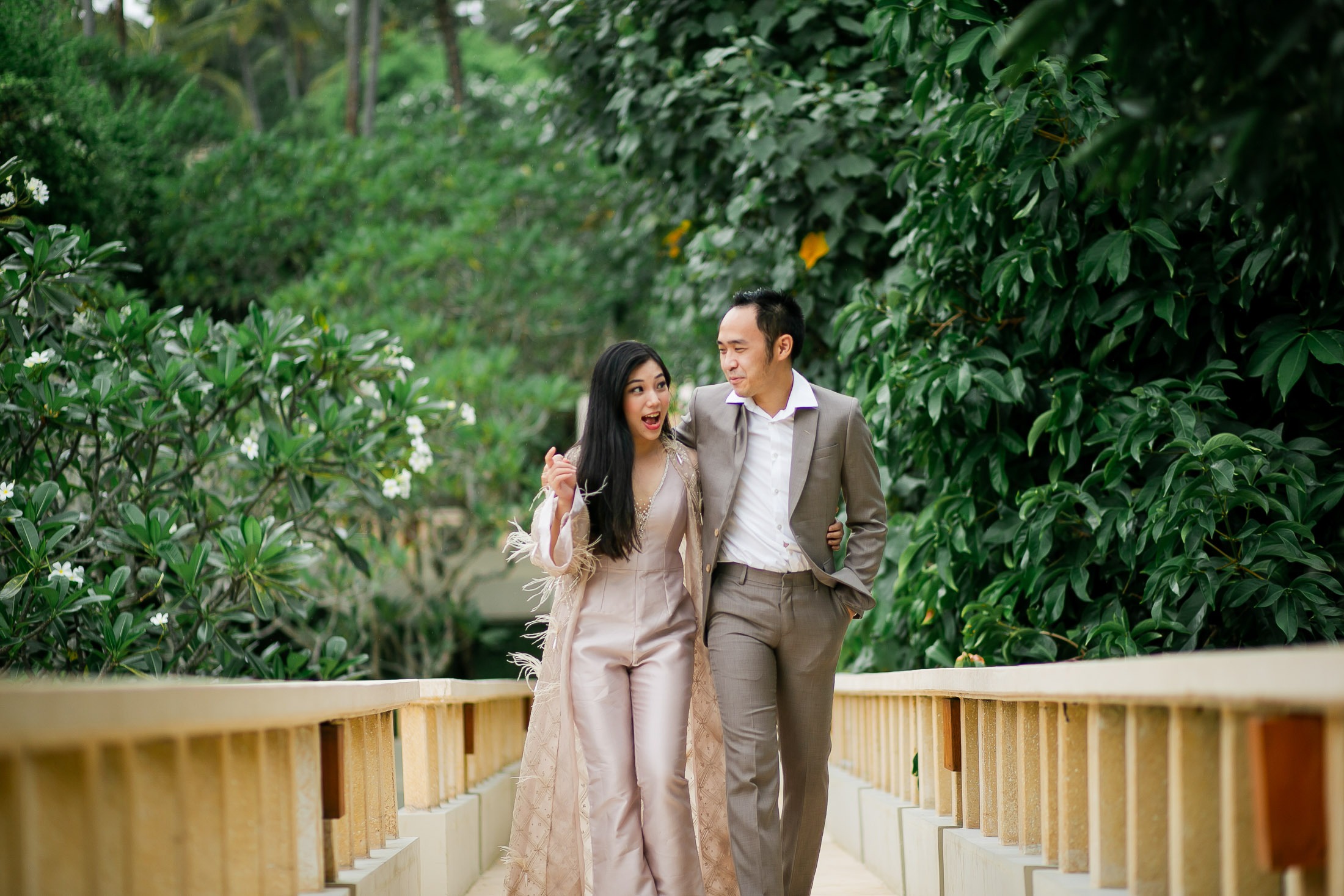 Romantic prewedding couple walking on garden bridge at Amankila Karangasem