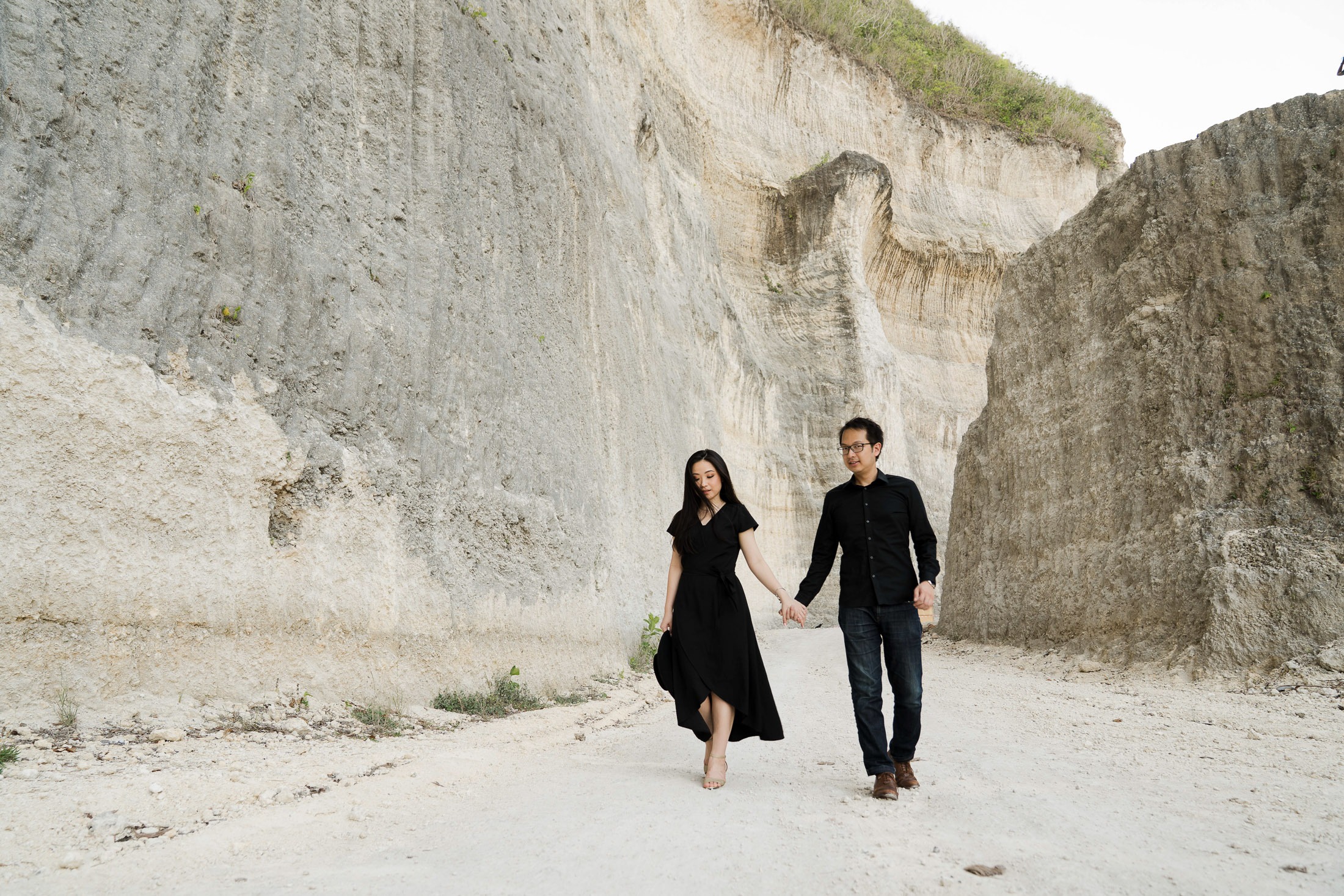 Romantic prewedding couple Candid walking along Melasti Beach cliffs in Bali