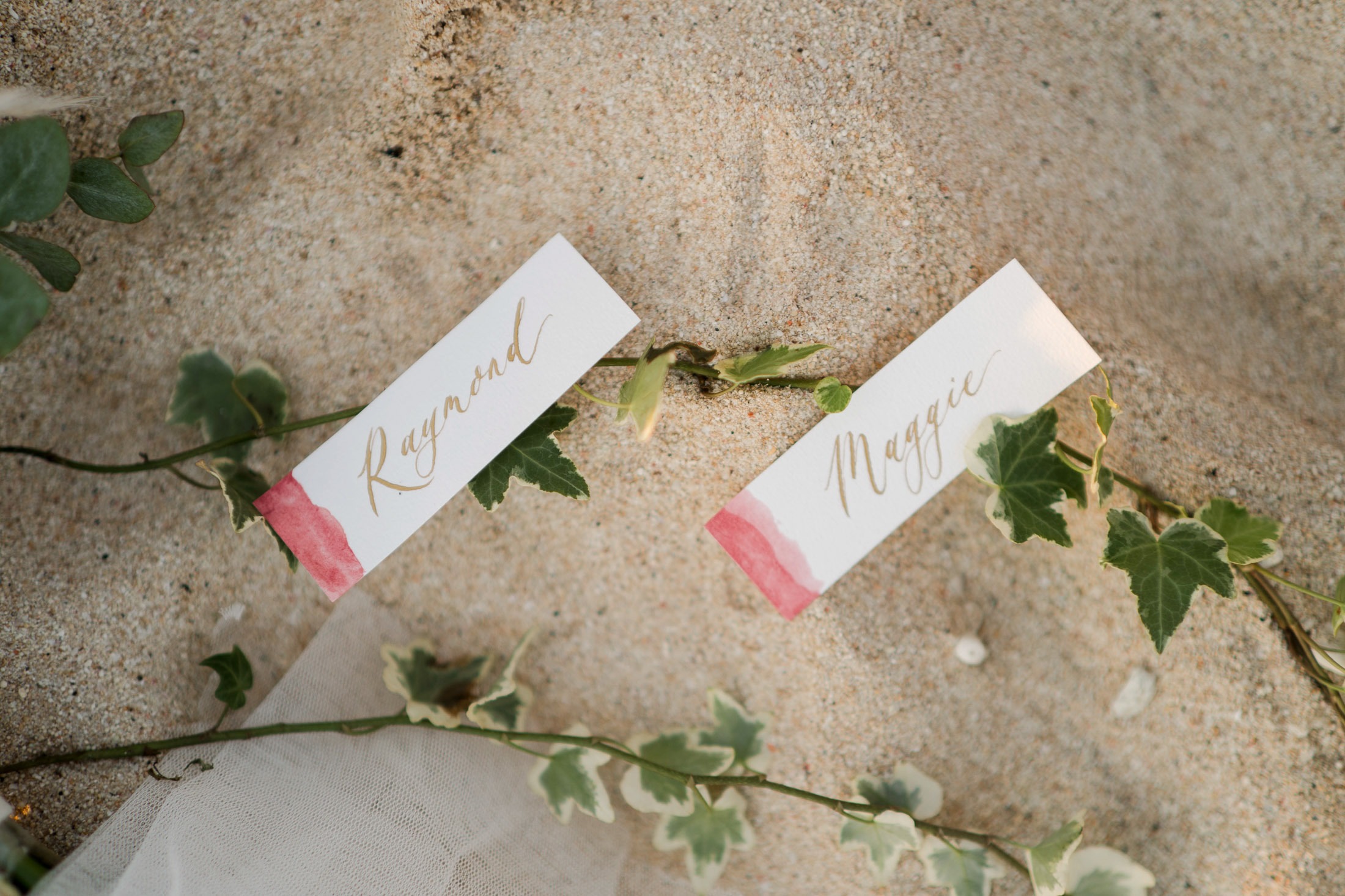 Luxury prewedding invitation detail on sand at Melasti Beach Bali