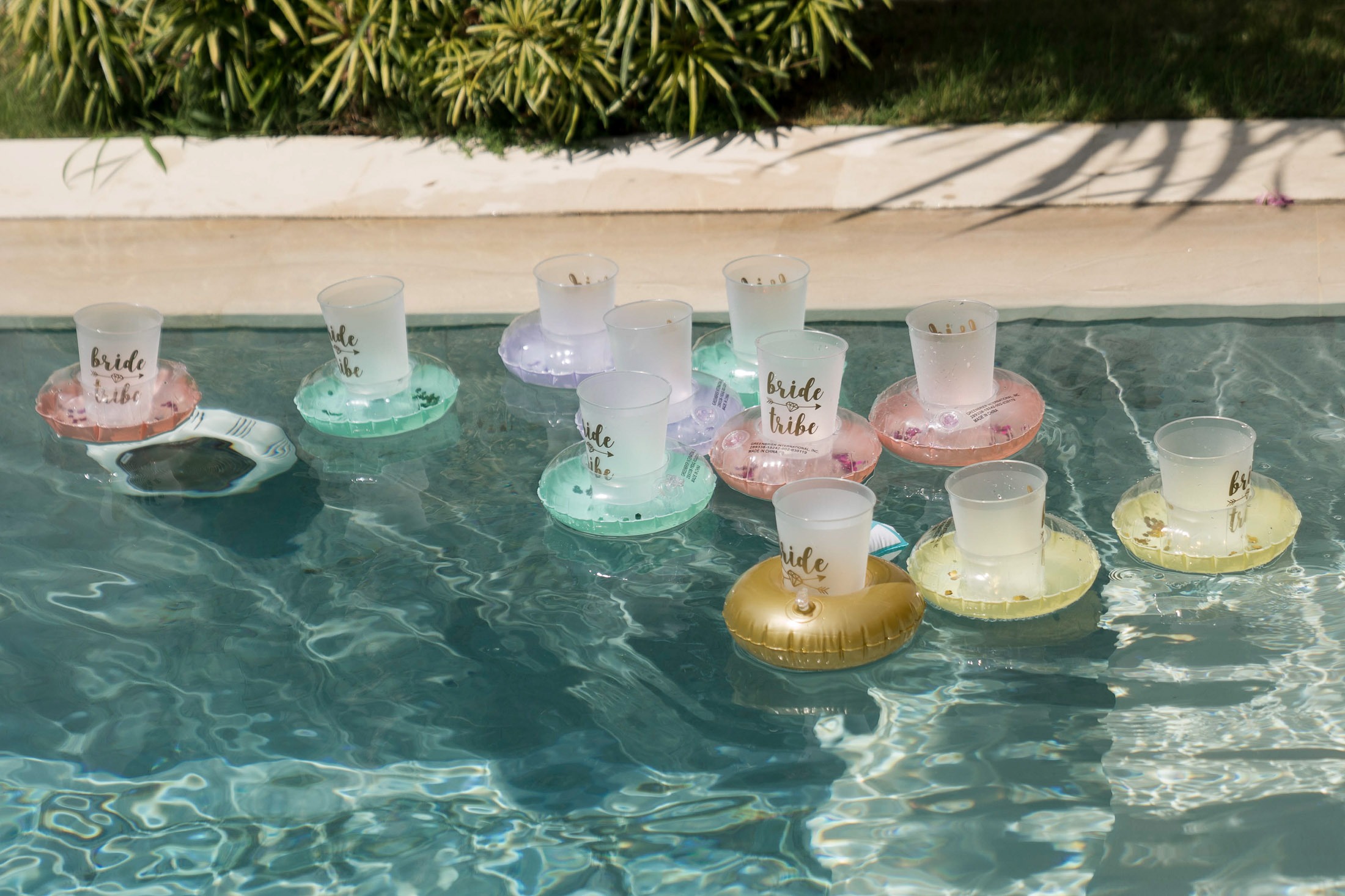 Poolside bridal party atmosphere with floating decorations during Regina celebration at Villa Seminyak Bali