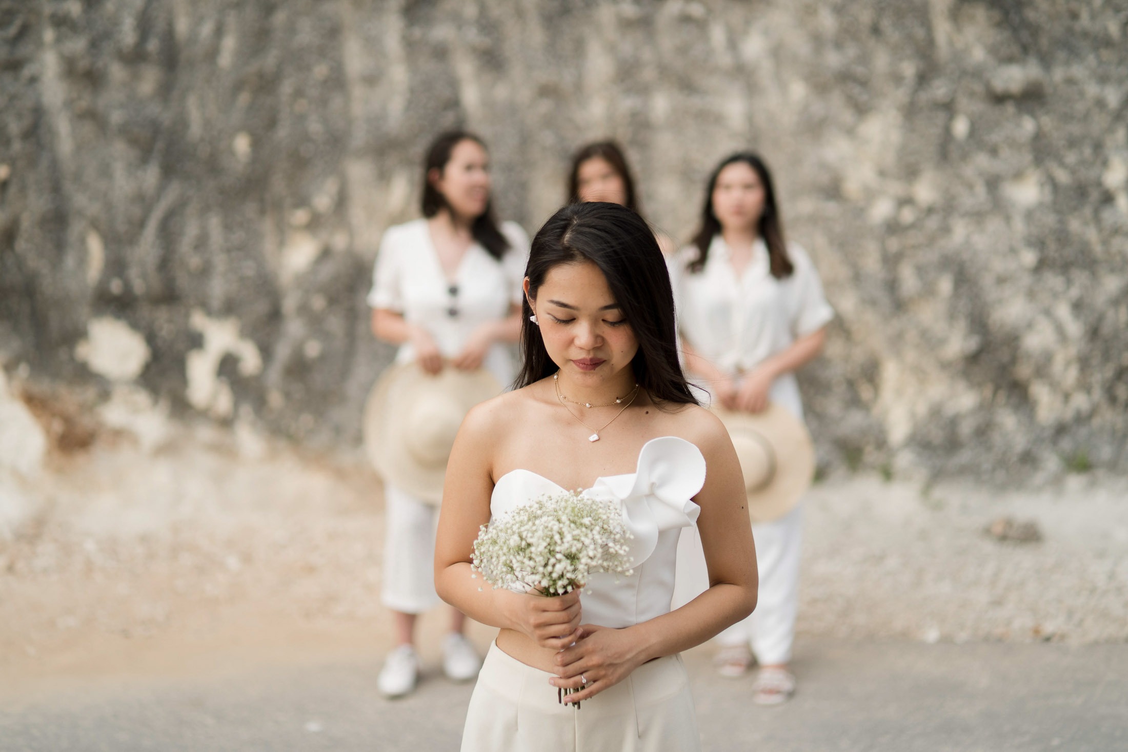 Bride portrait walking along Melasti Beach Bali during sunset light