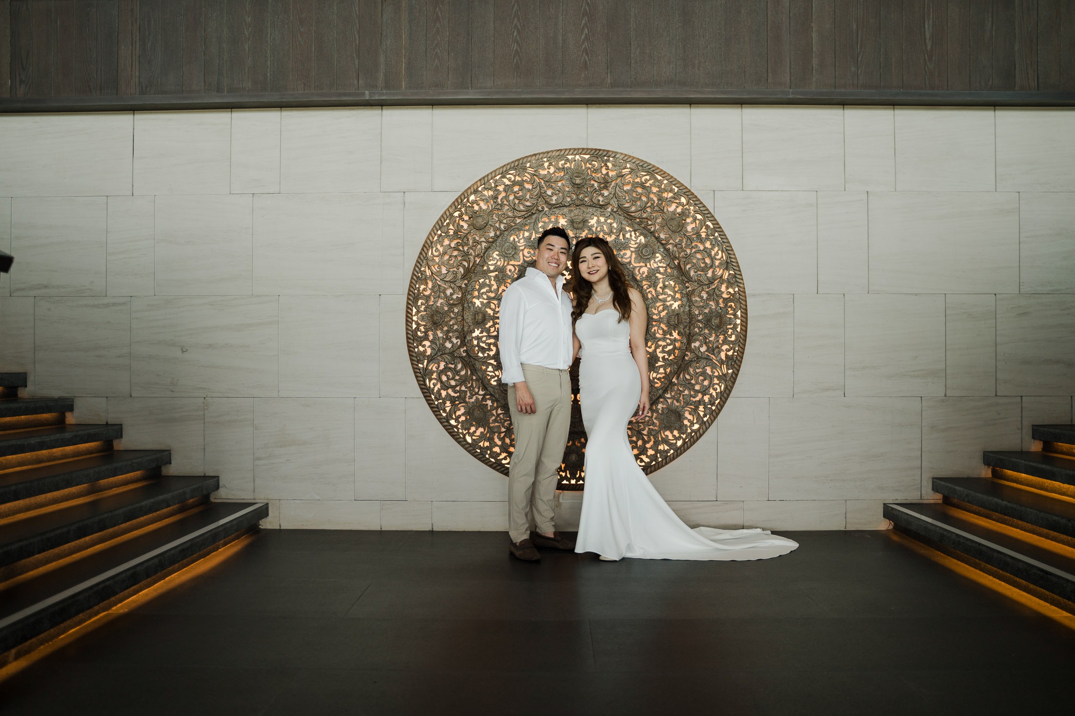 Couple portrait during a prewedding photoshoot at the grand staircase of Apurva Kempinski Bali resort