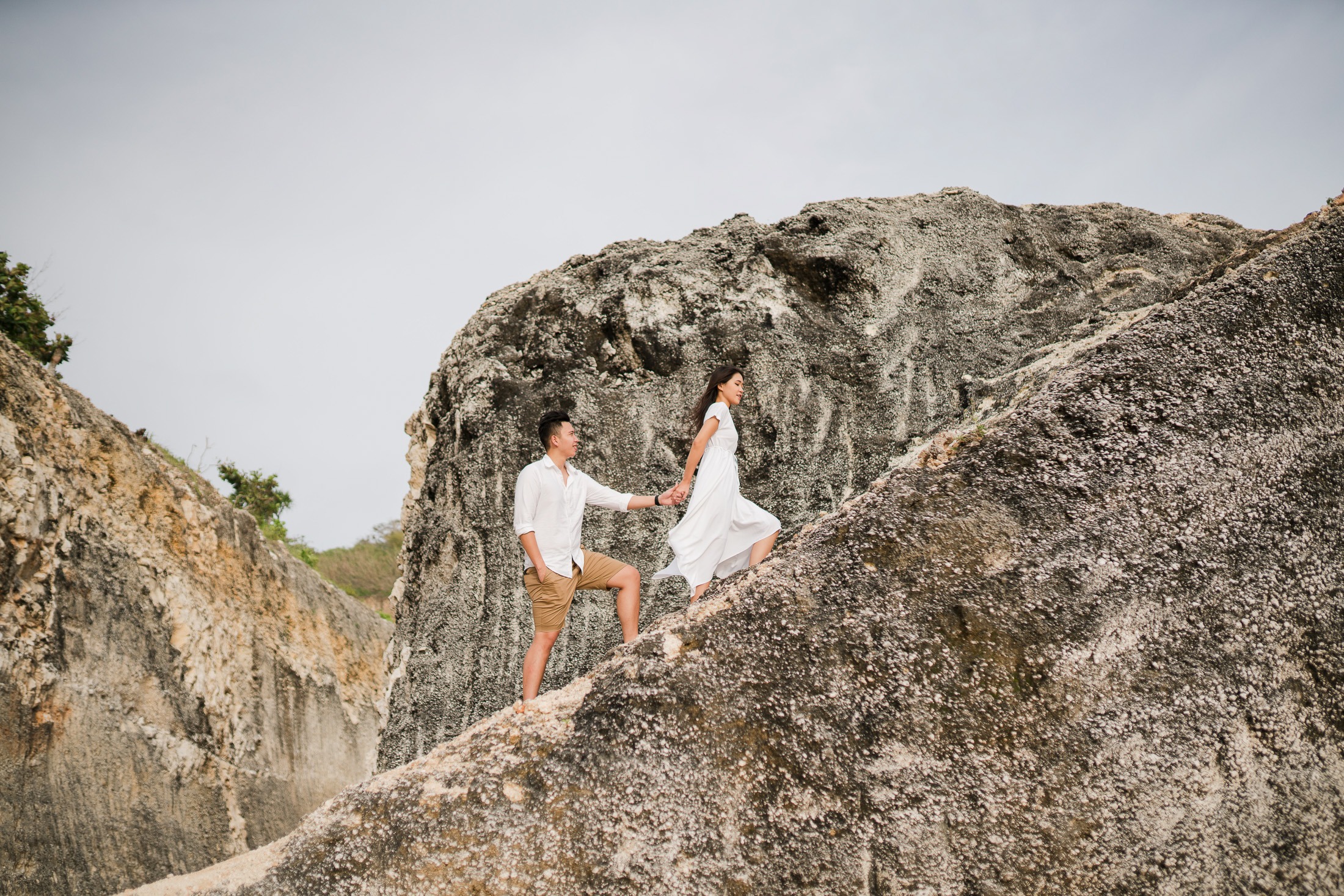 Couple walking on a cliff before proposal at Melasti Beach Bali