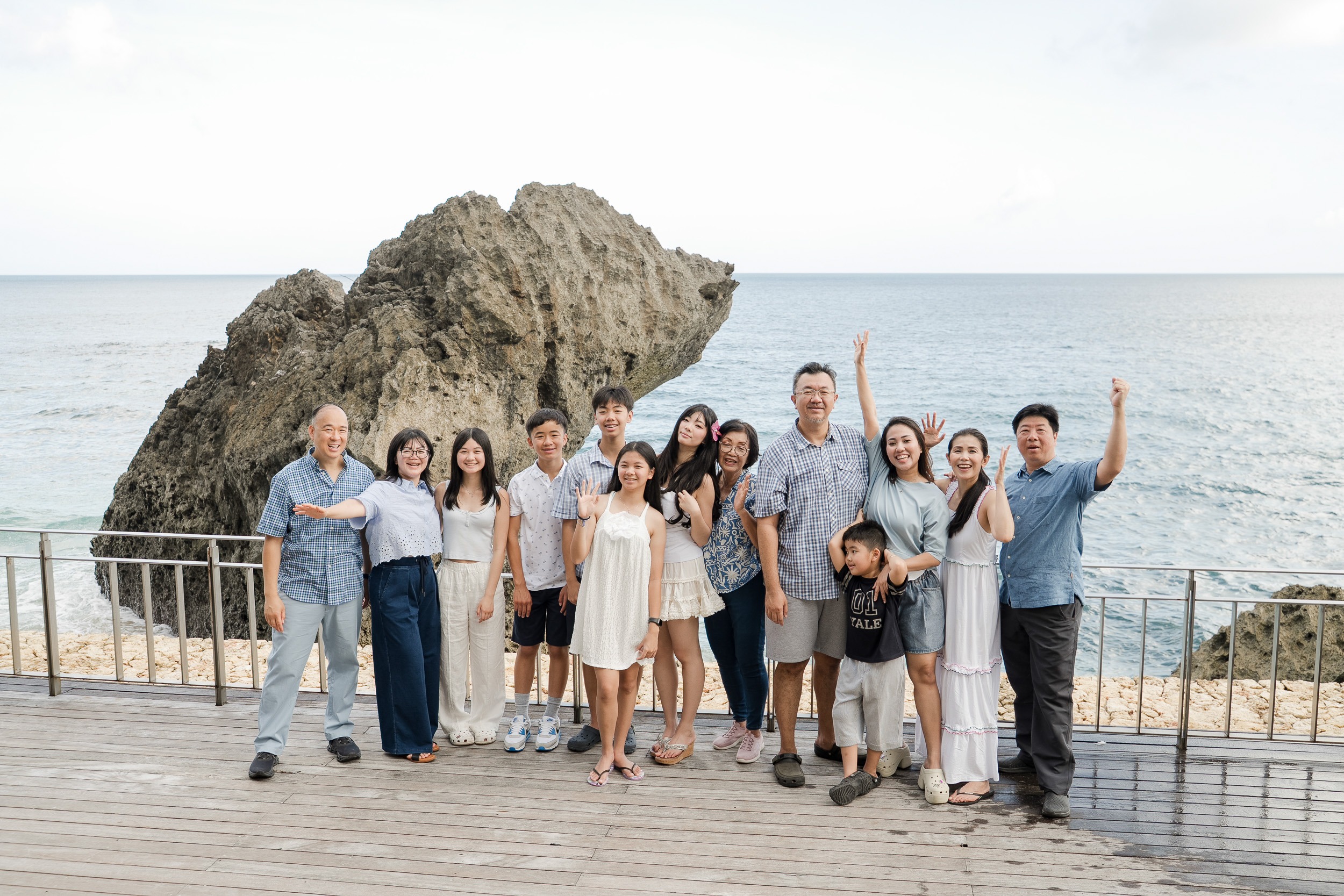 Extended family enjoying a candid joyful moment together during a sunset session at Ayana Jimbaran Bali