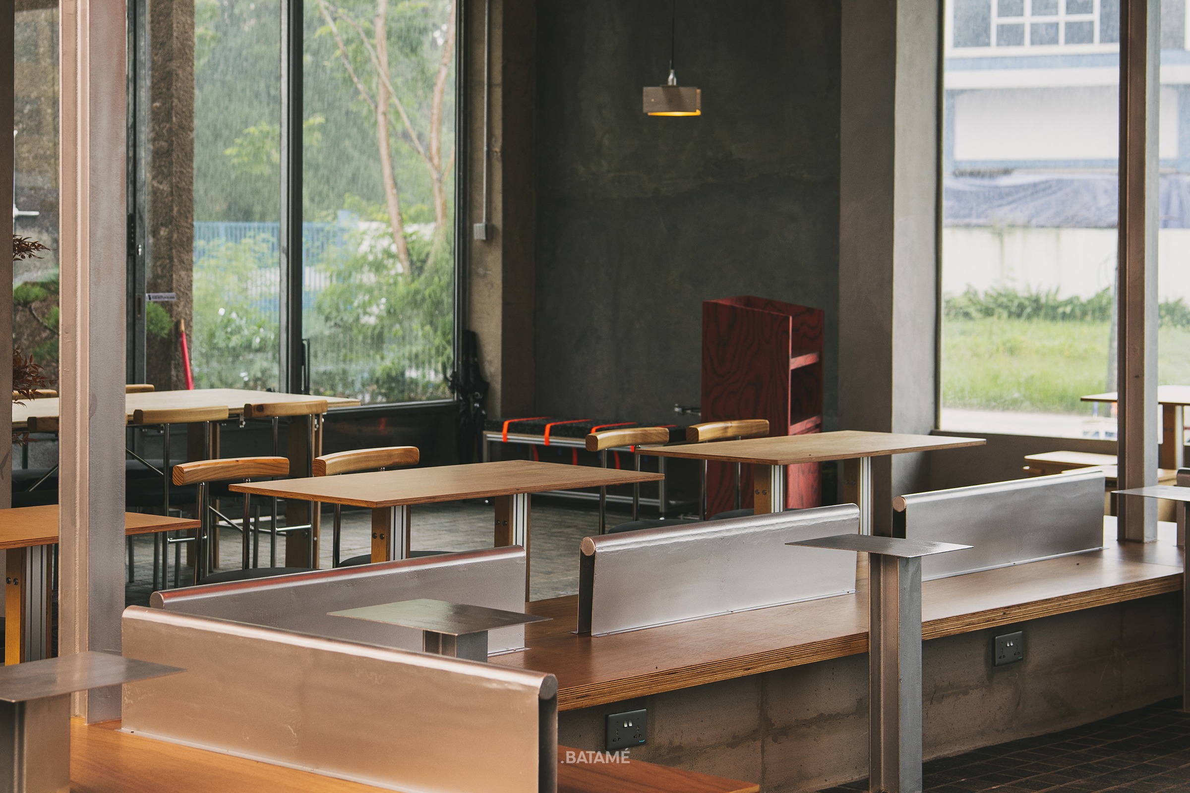 spacious wooden seating area under brutalist interior at odd Batam