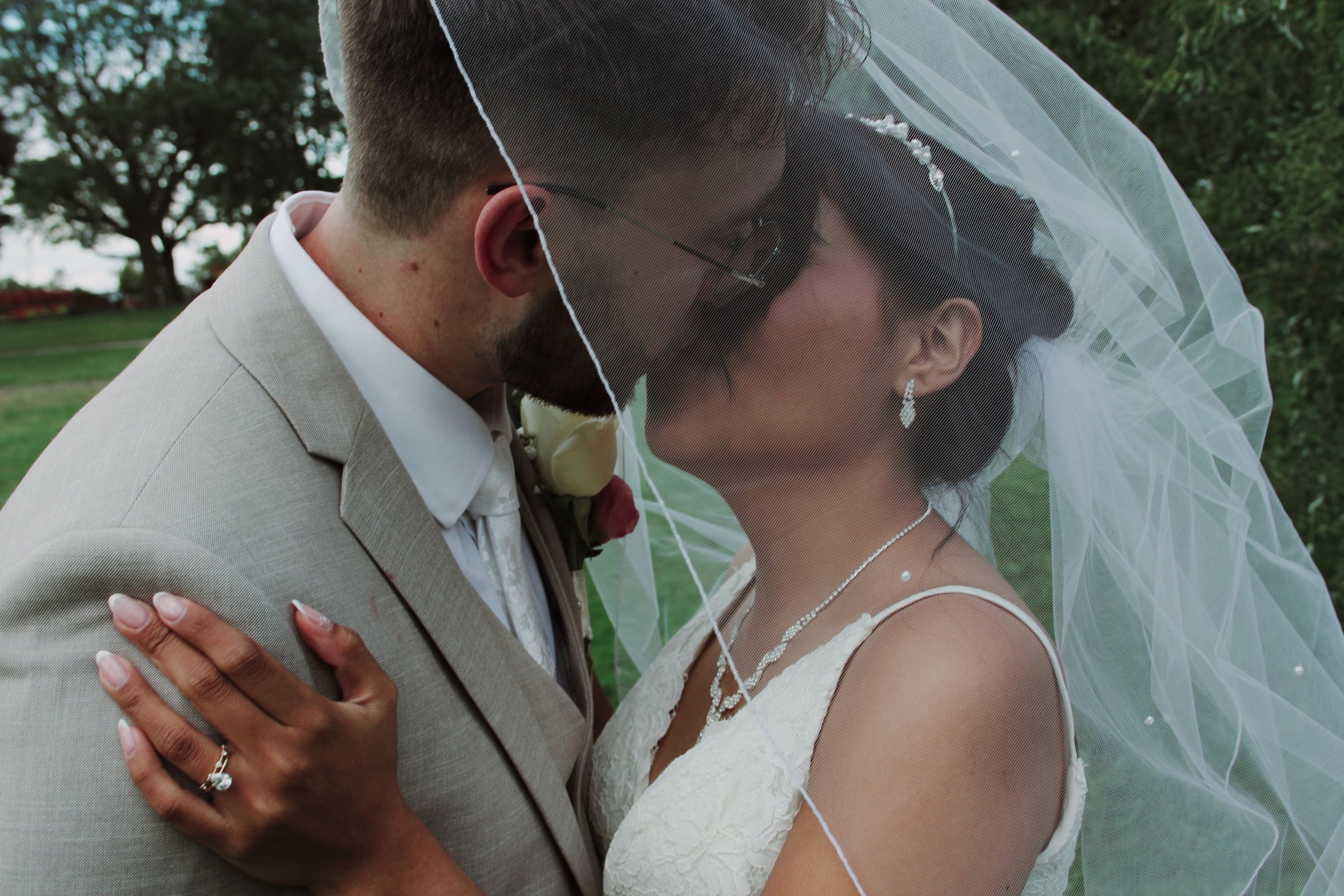 Candid moment of bride and groom kissing during Toronto wedding photographed authentically