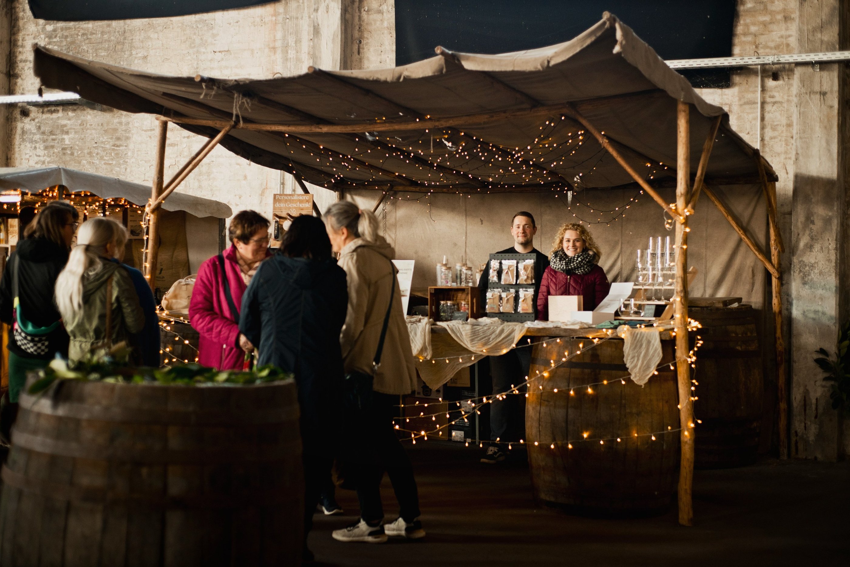 a group of people standing around a table with wine glasses