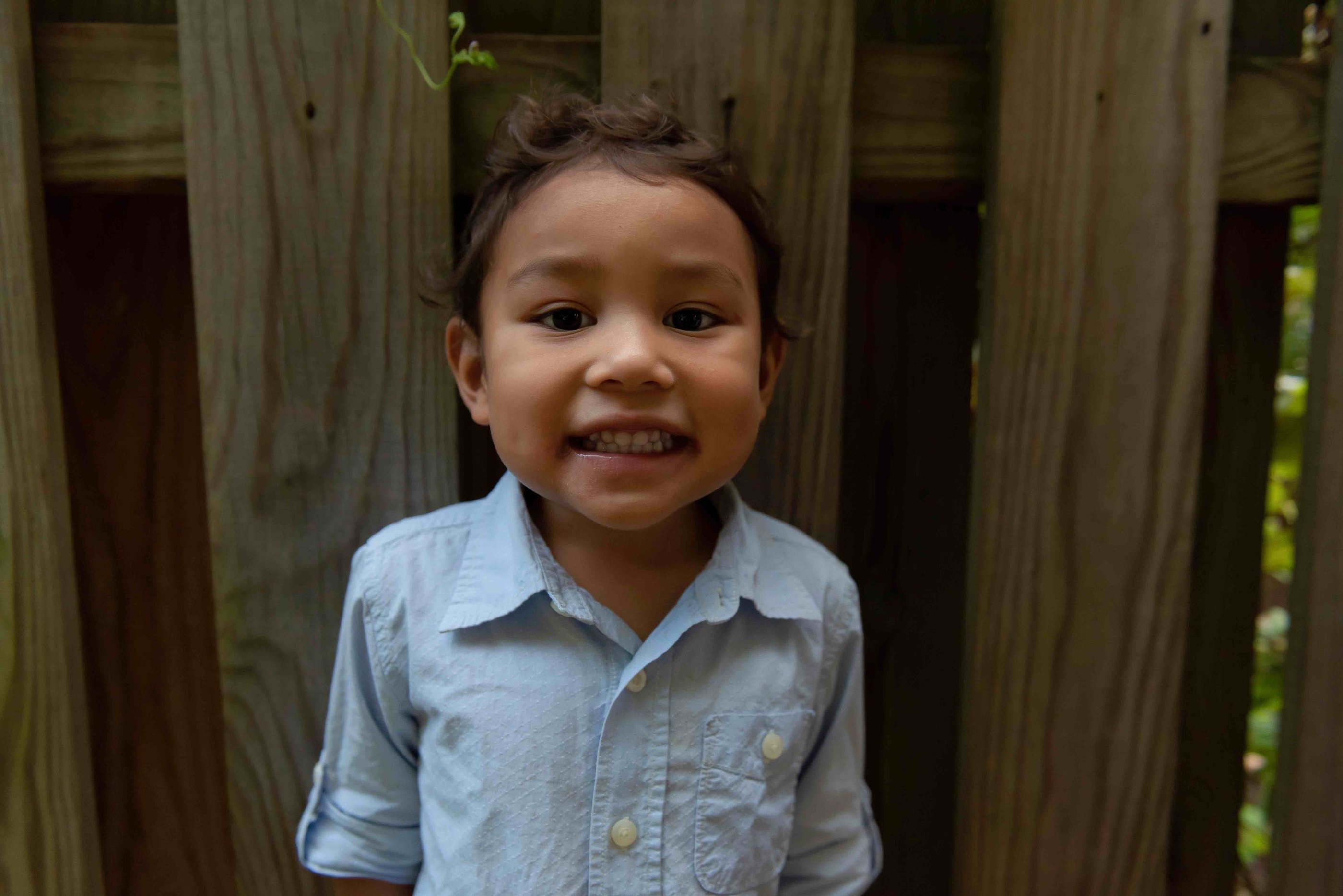 A young boy smiling at the camera.