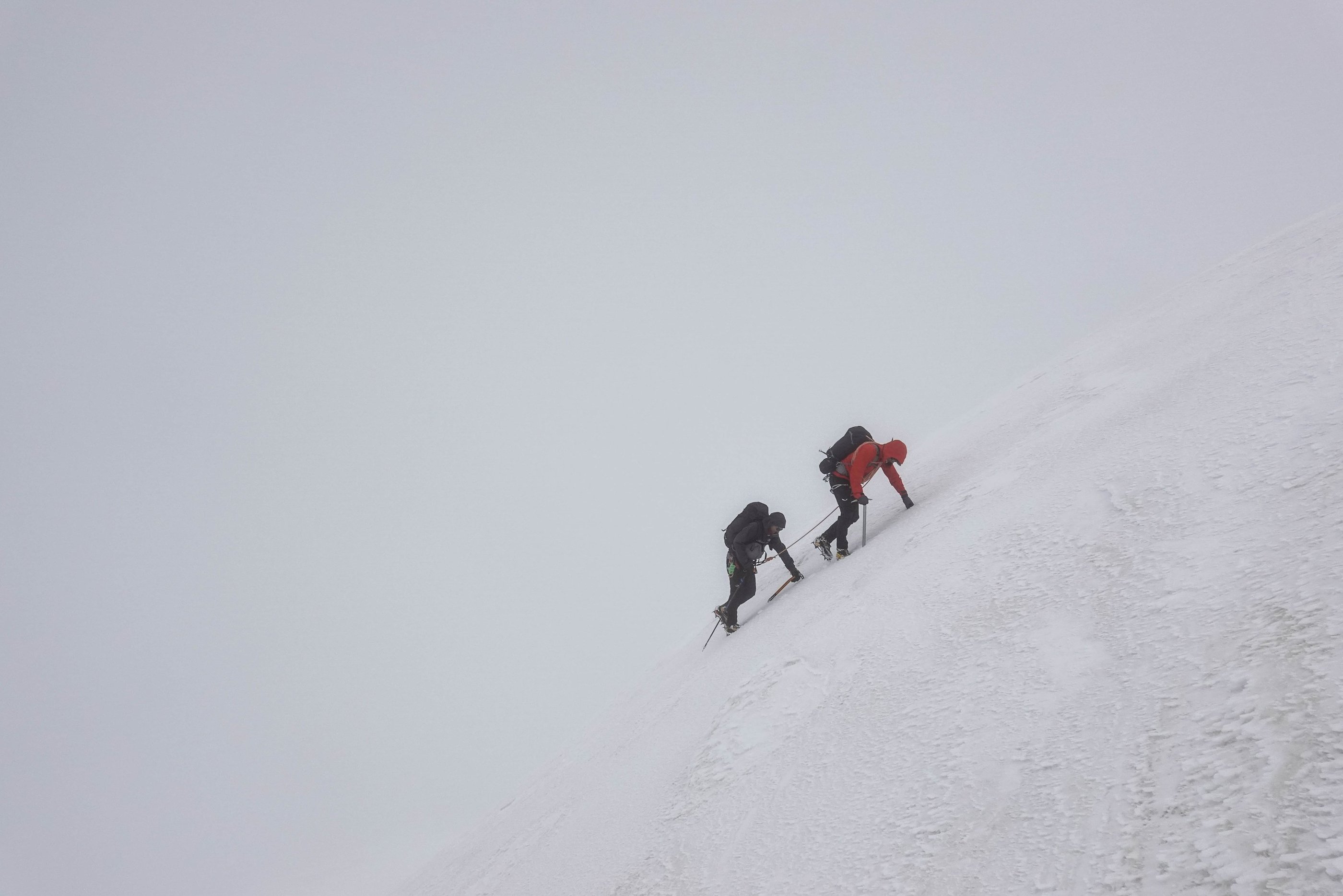 two climbers in the snow, mountain guide and coach, mist, ice