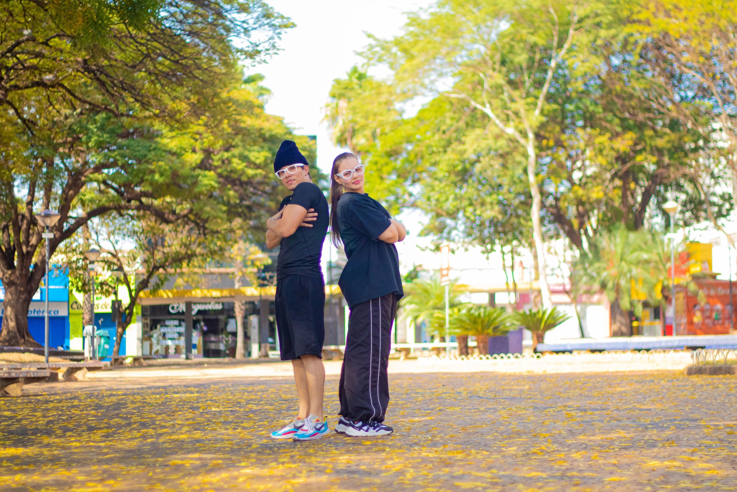 a couple of people standing in a park