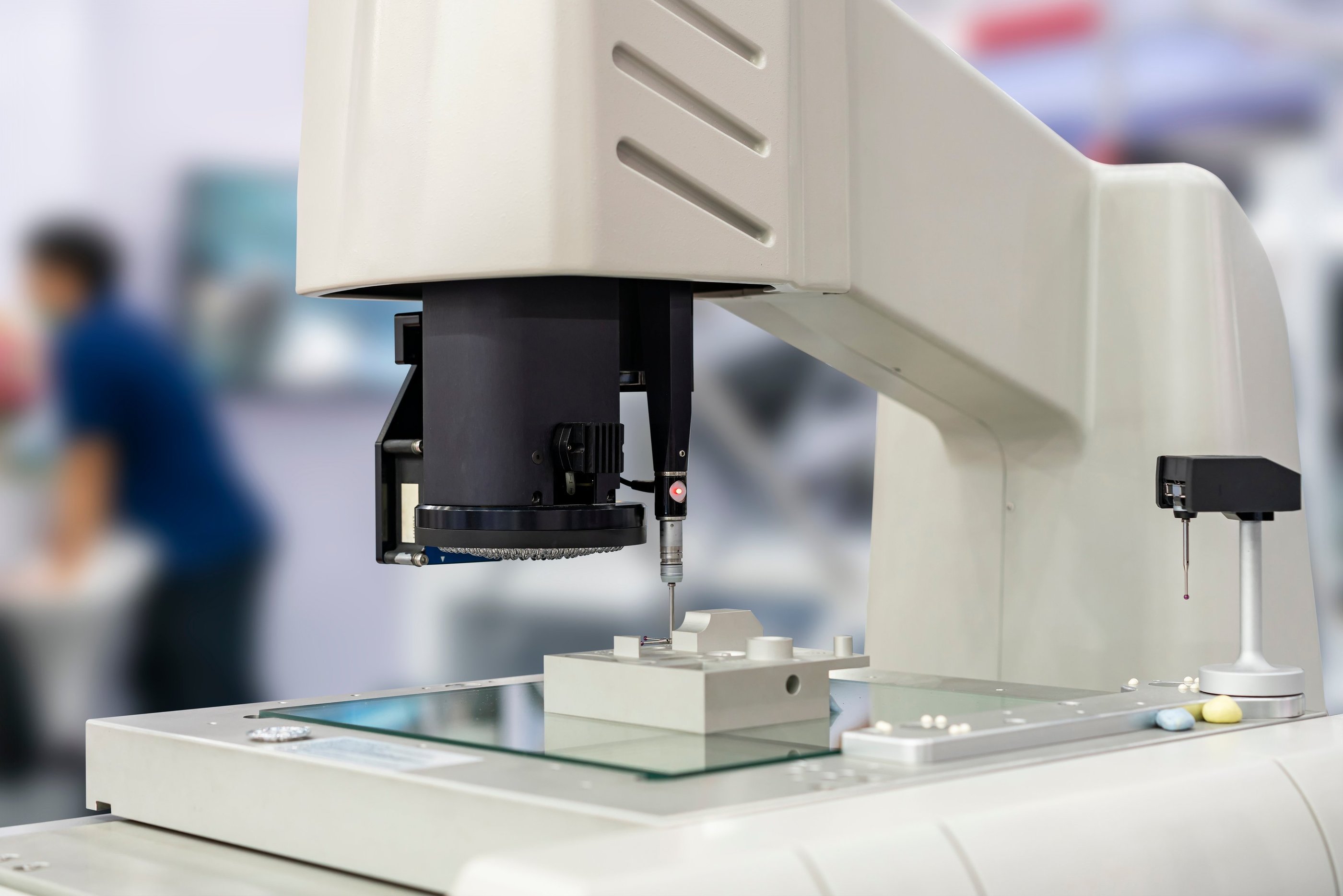 Micro-Vu optical CMM performing a CMM touch probe on a machined part.