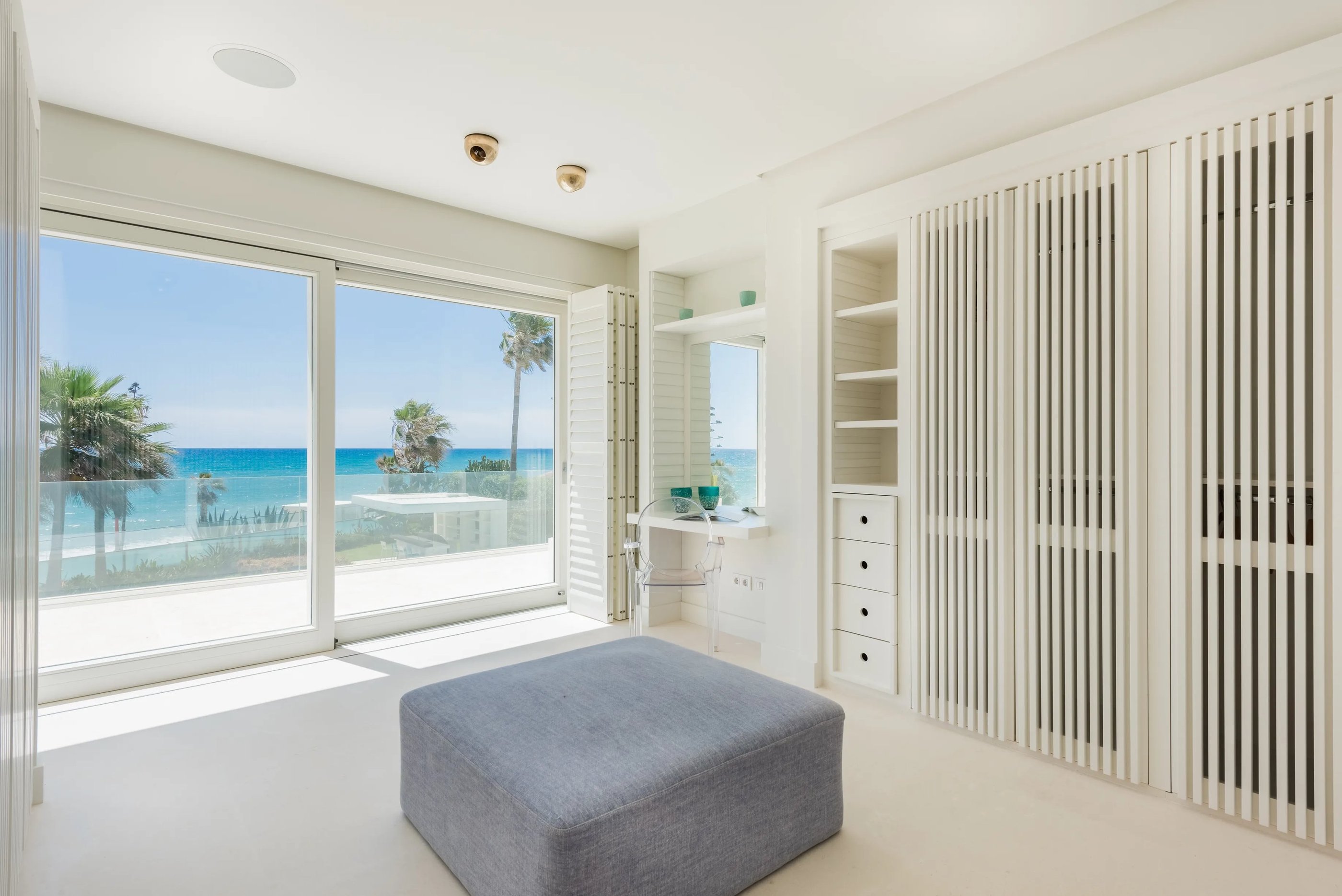 Sea-view bedroom with built-in storage and desk