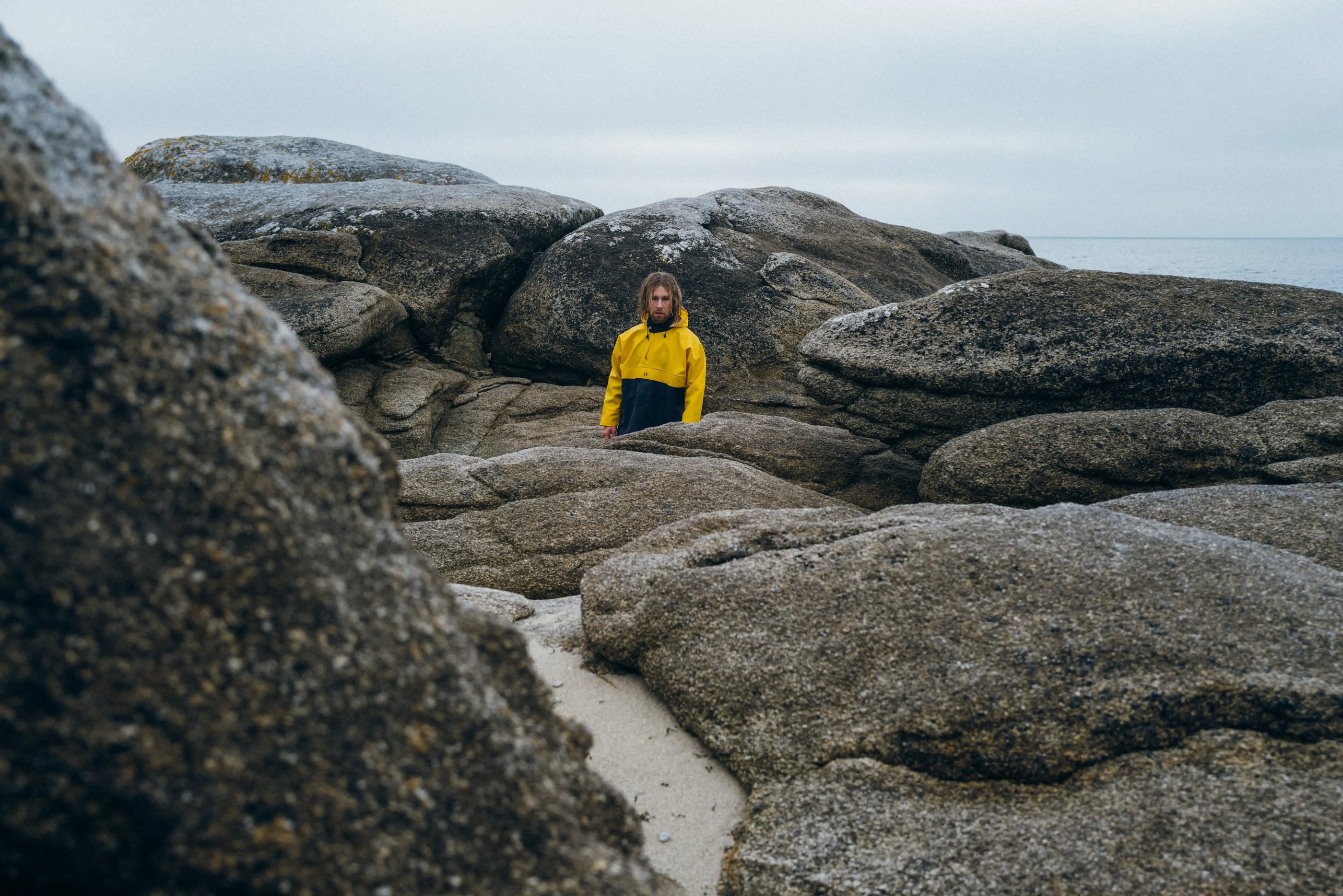 ardent ardent32m in a yellow jacket standing on a rock