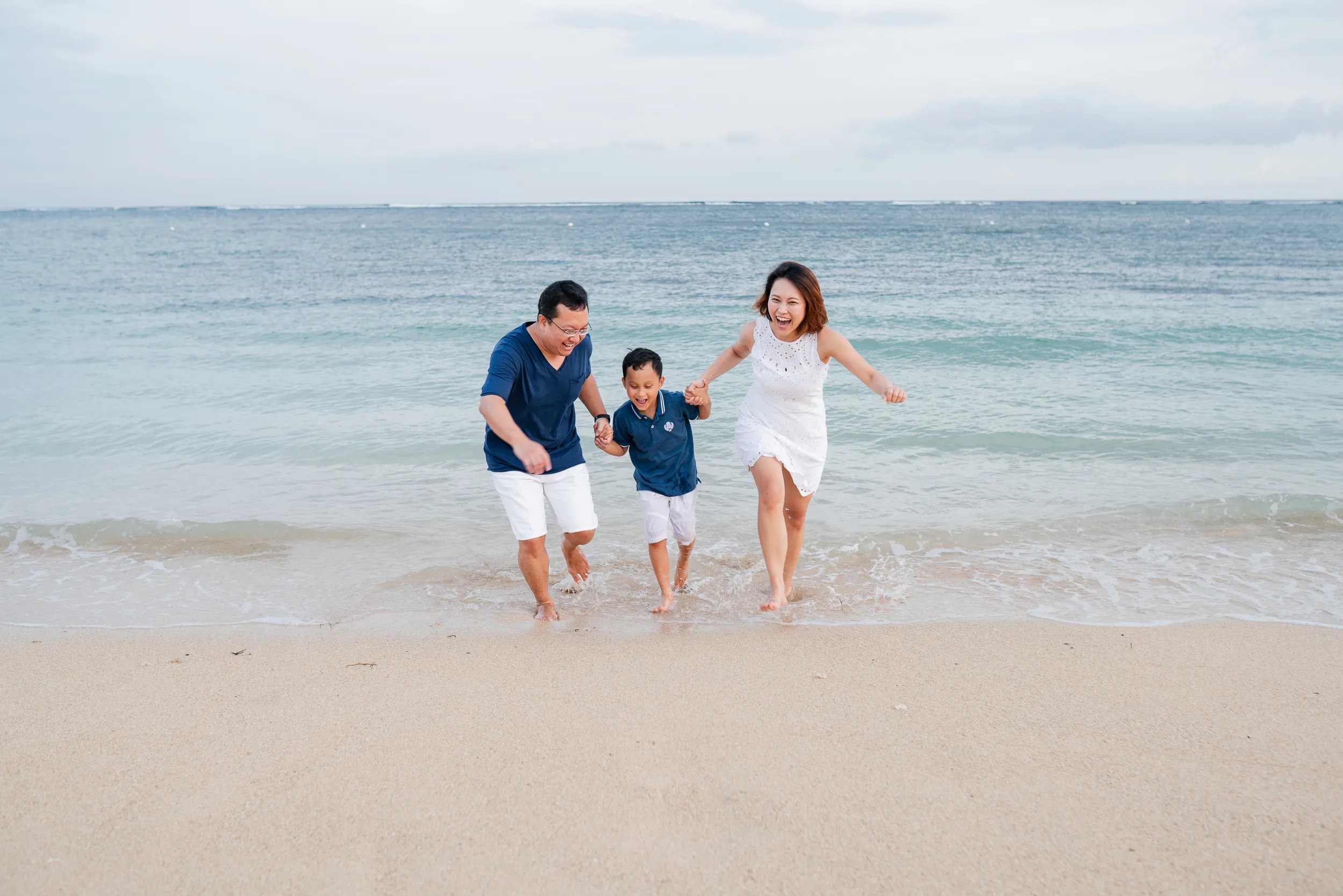 Family photography session walking on the beach at The Mulia Nusa Dua Bali