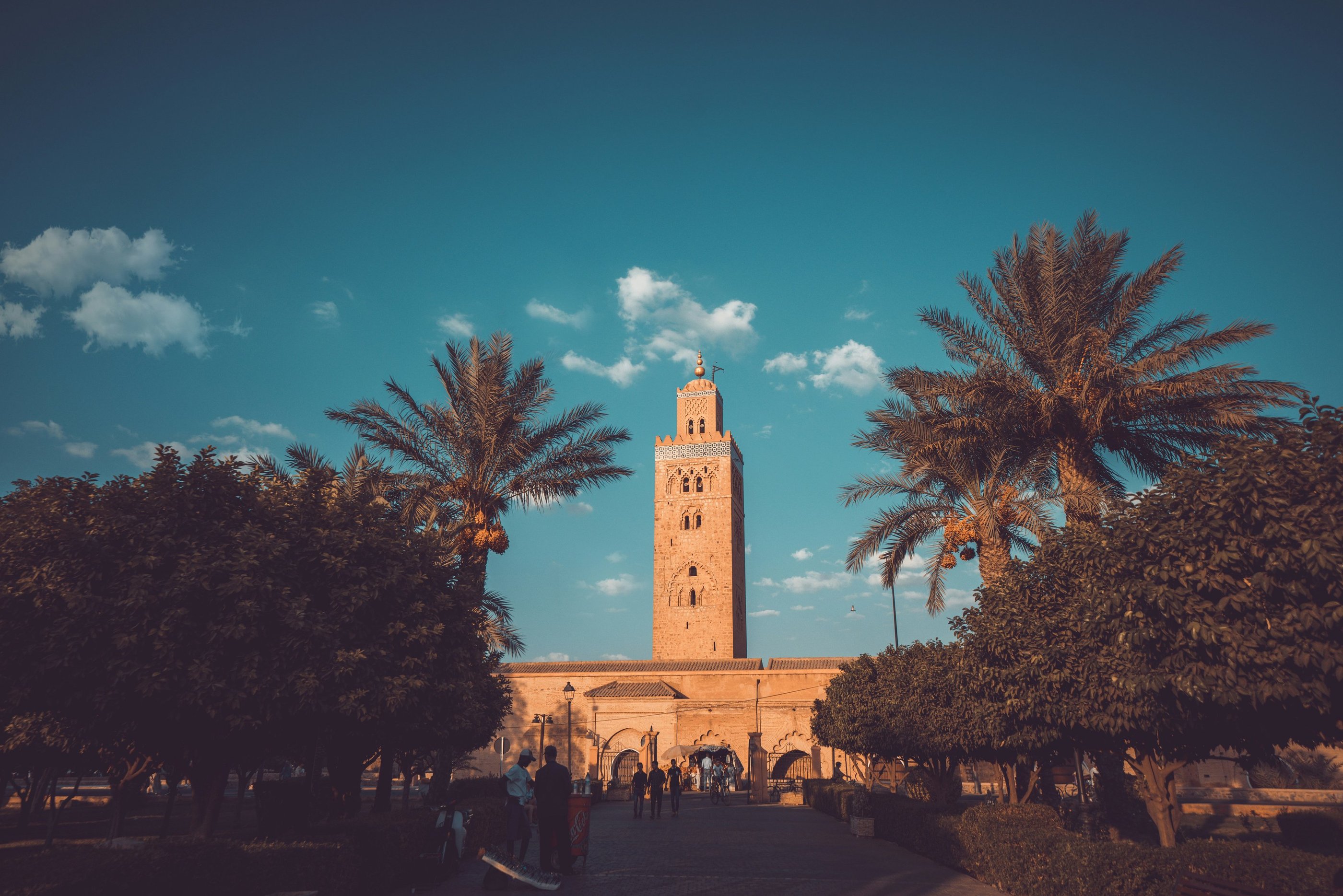 Koutoubia Mosque in Marrakech Morocco with palm trees and blue sky