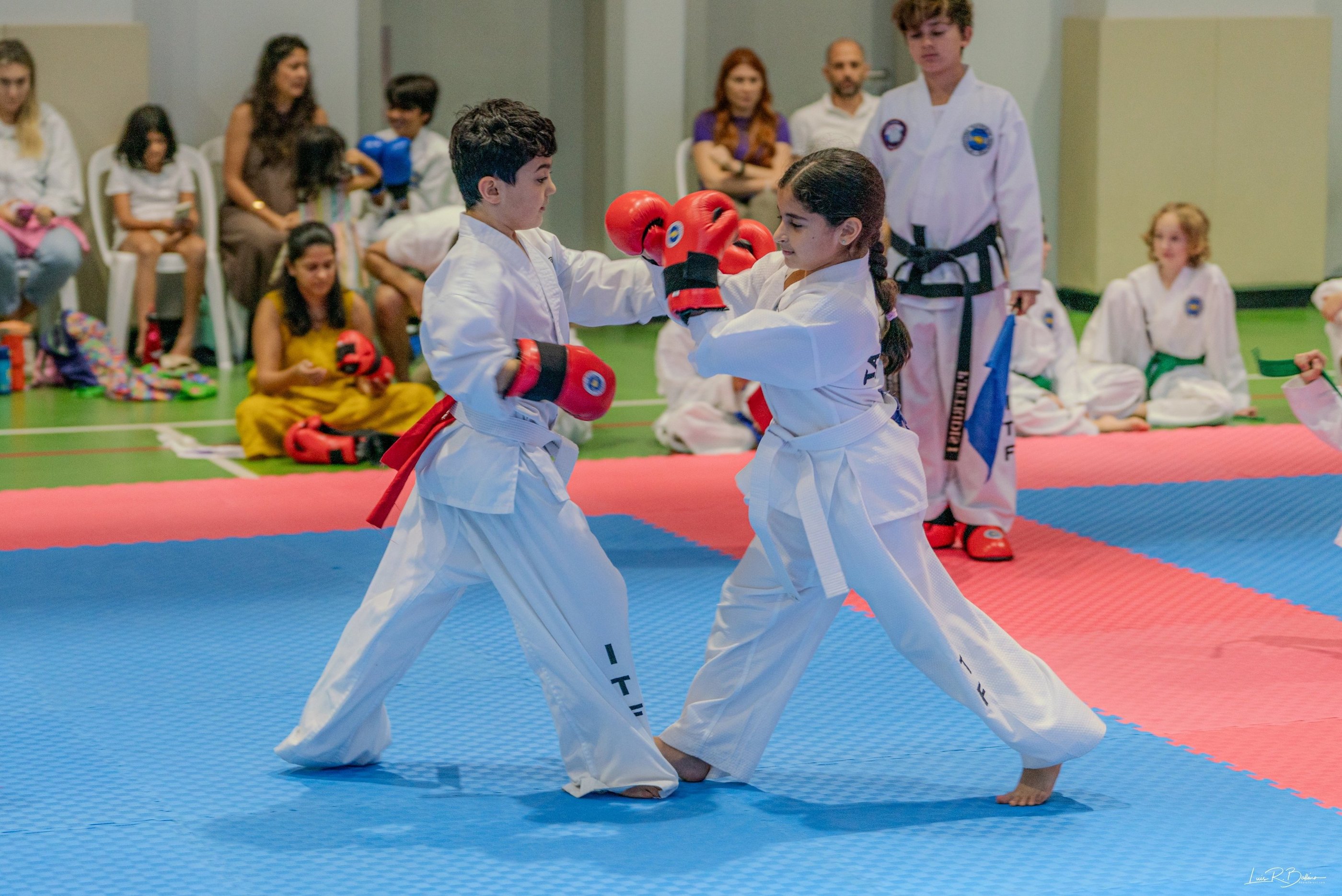 Junior ITF taekwondo students sparring in training match, Dubai