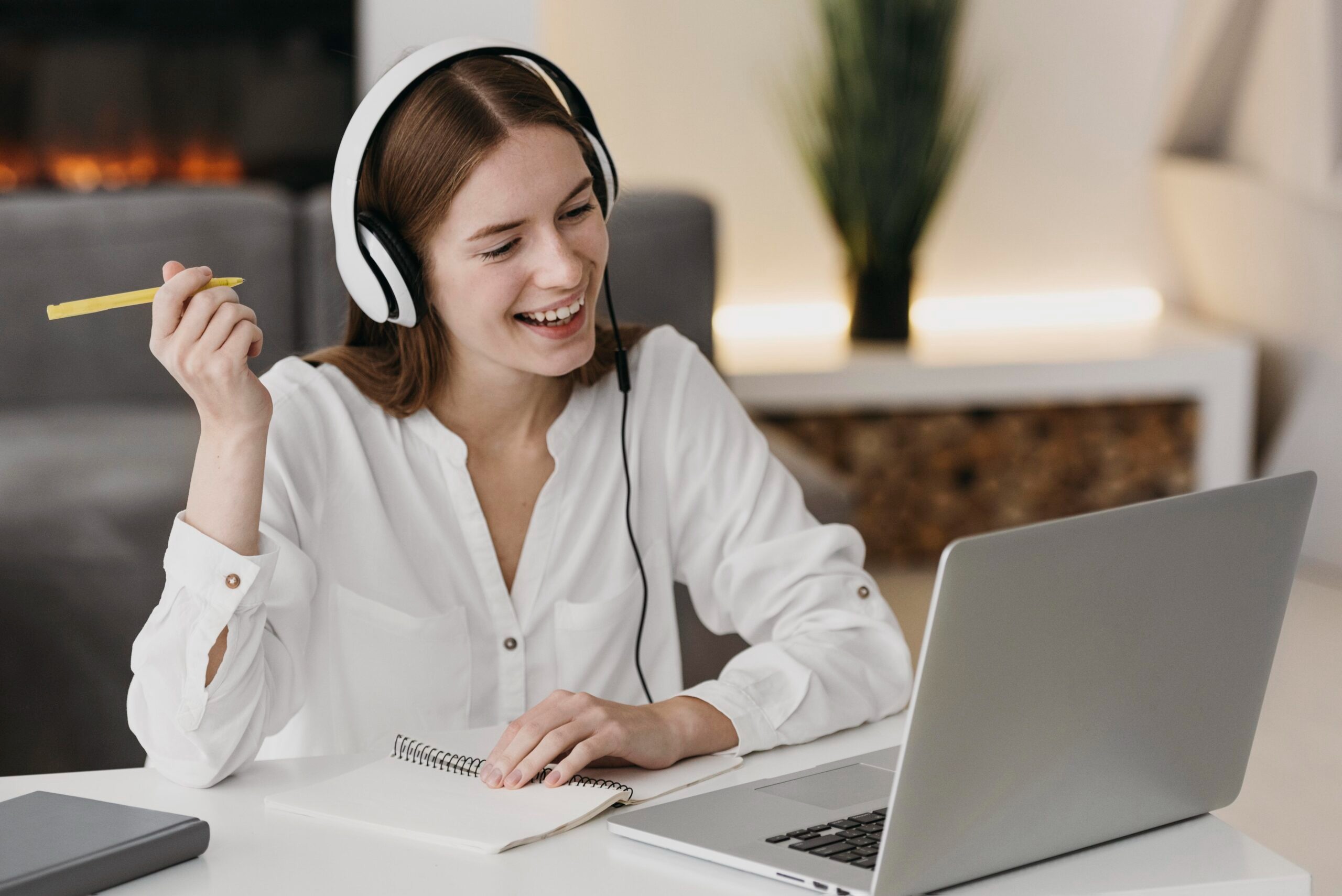 a woman with headphones and headphones on a laptop