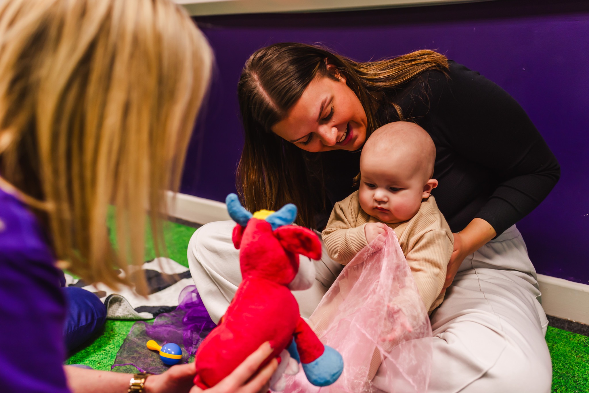 Mum looking over and smiling at her baby in Moo Music Worksop.