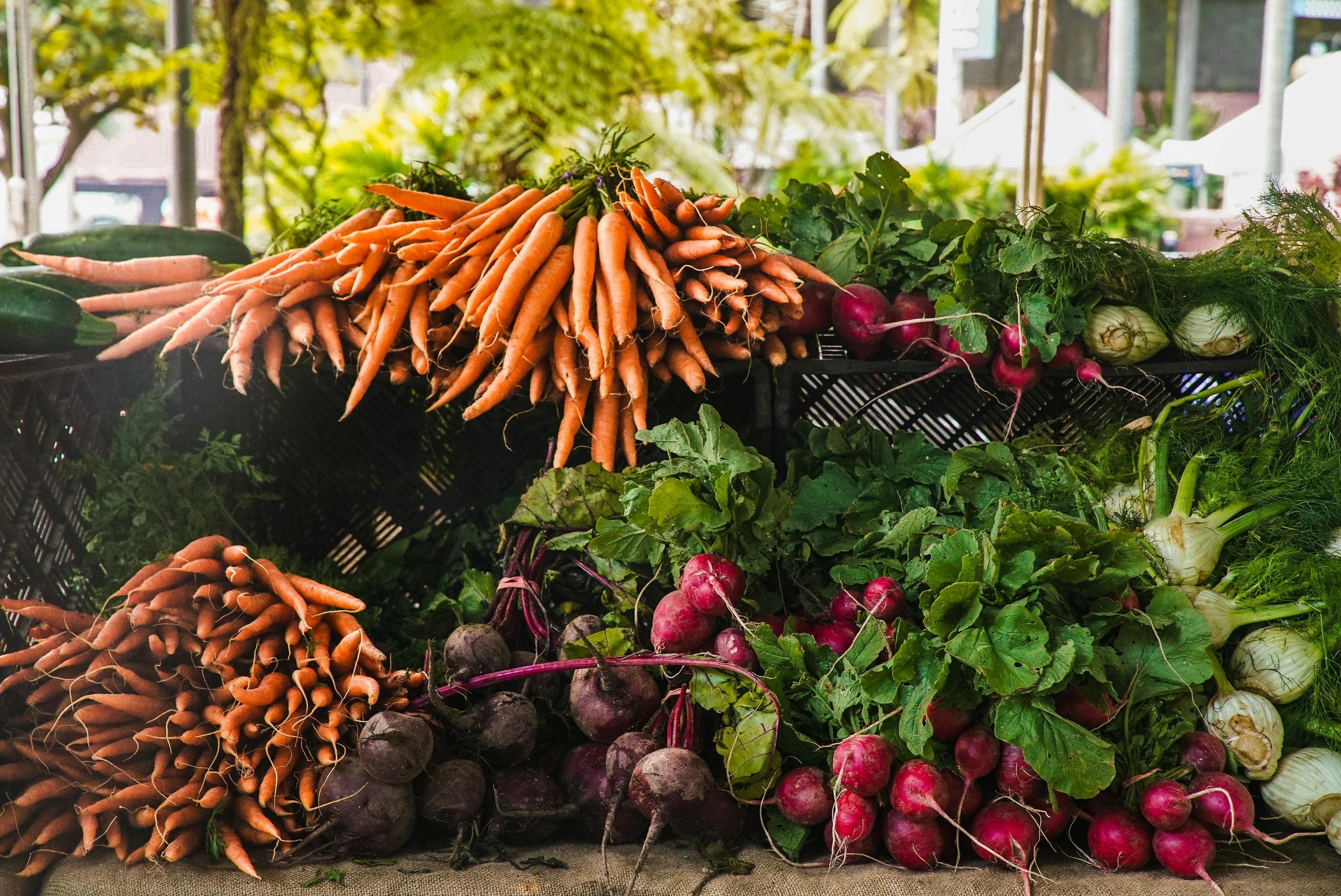 a bunch of vegetables are on display in a market
