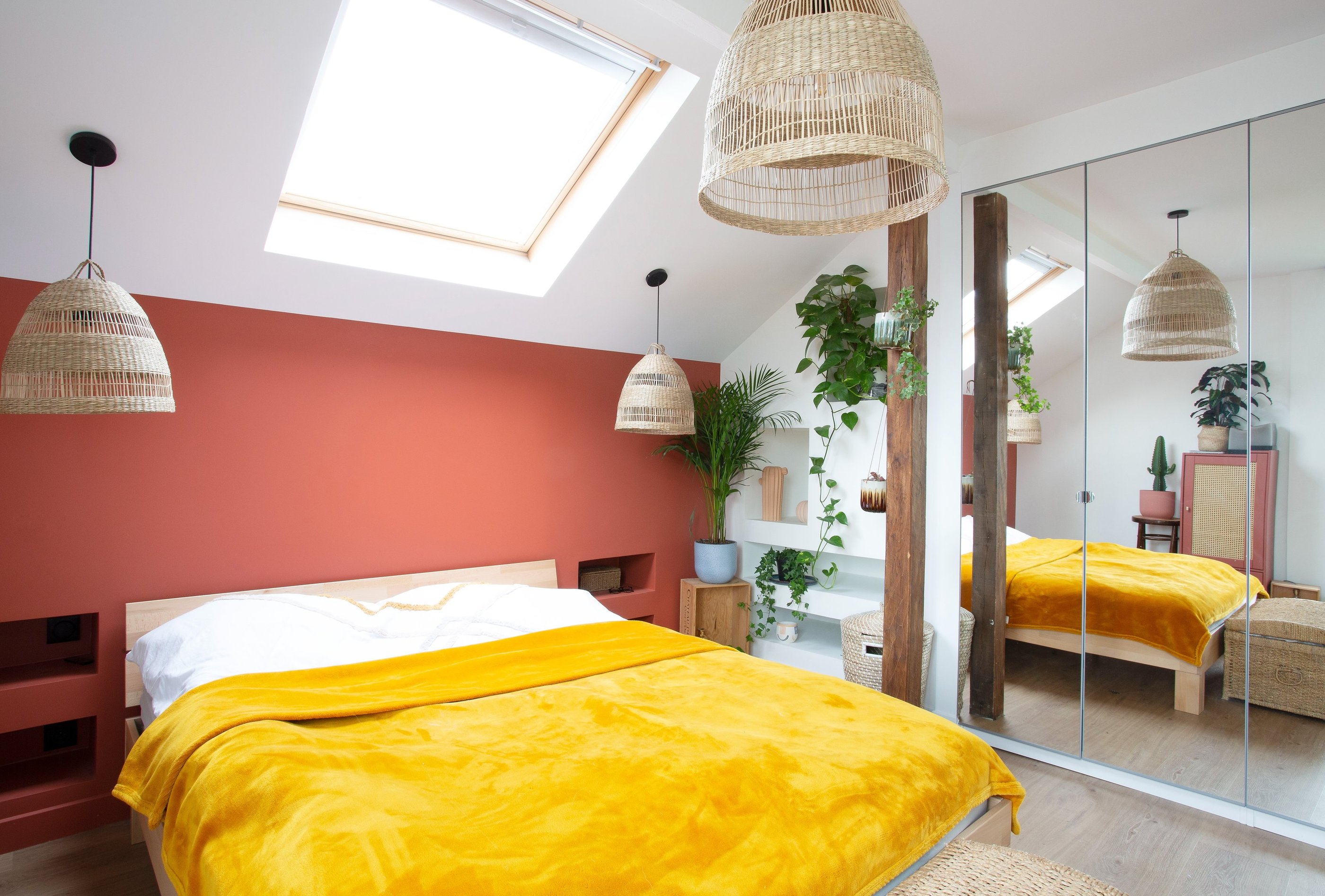 a bedroom with a bed and a mirror